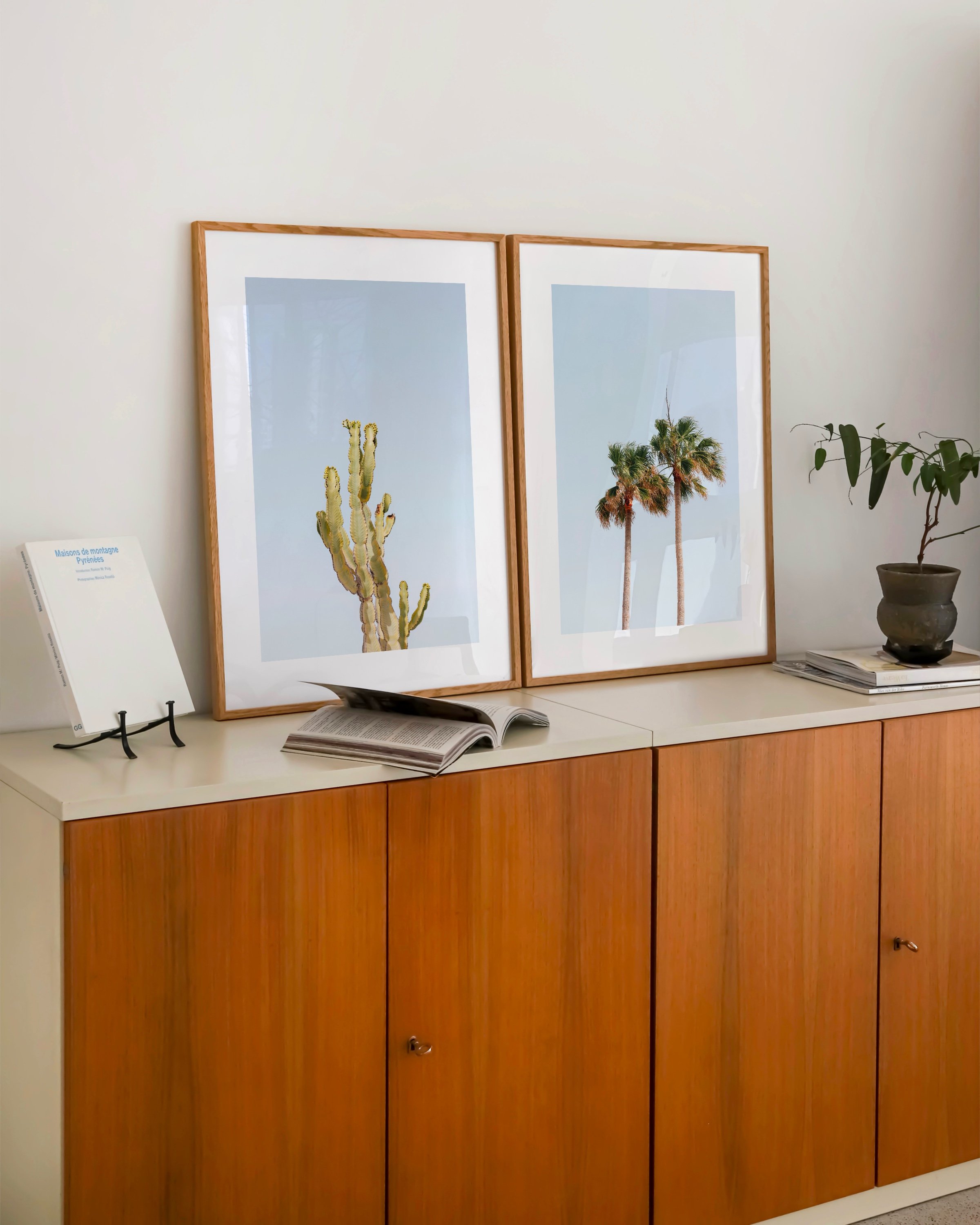 Two printable art prints: one featuring a cactus and the other showcasing palm trees, both set against a clear blue sky.
