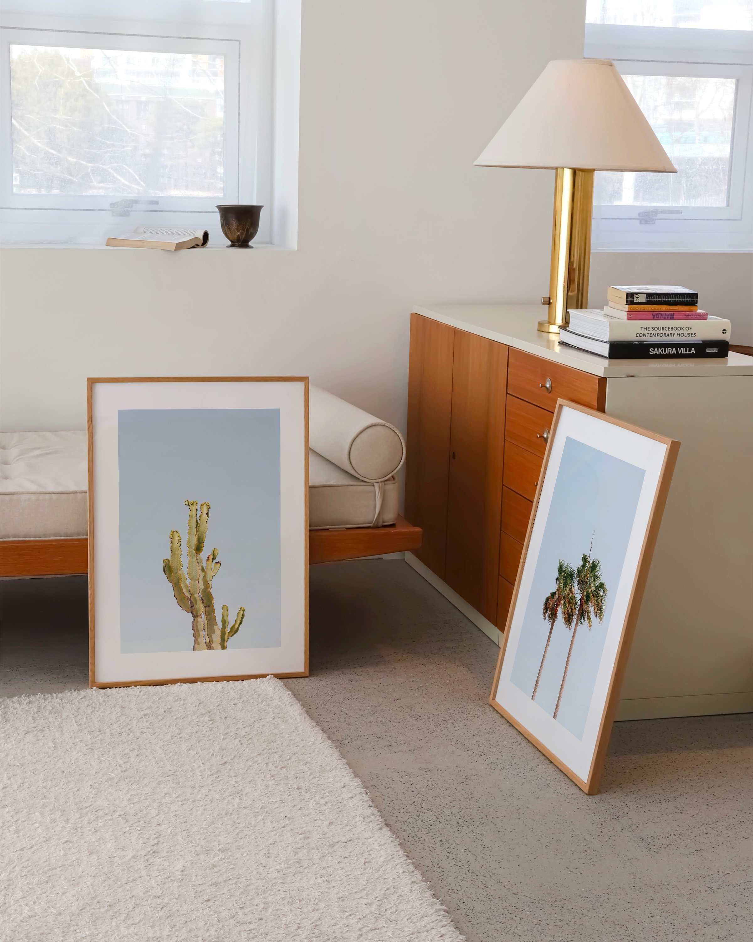 Two printable art prints: one featuring a cactus and the other showcasing palm trees, both set against a clear blue sky.