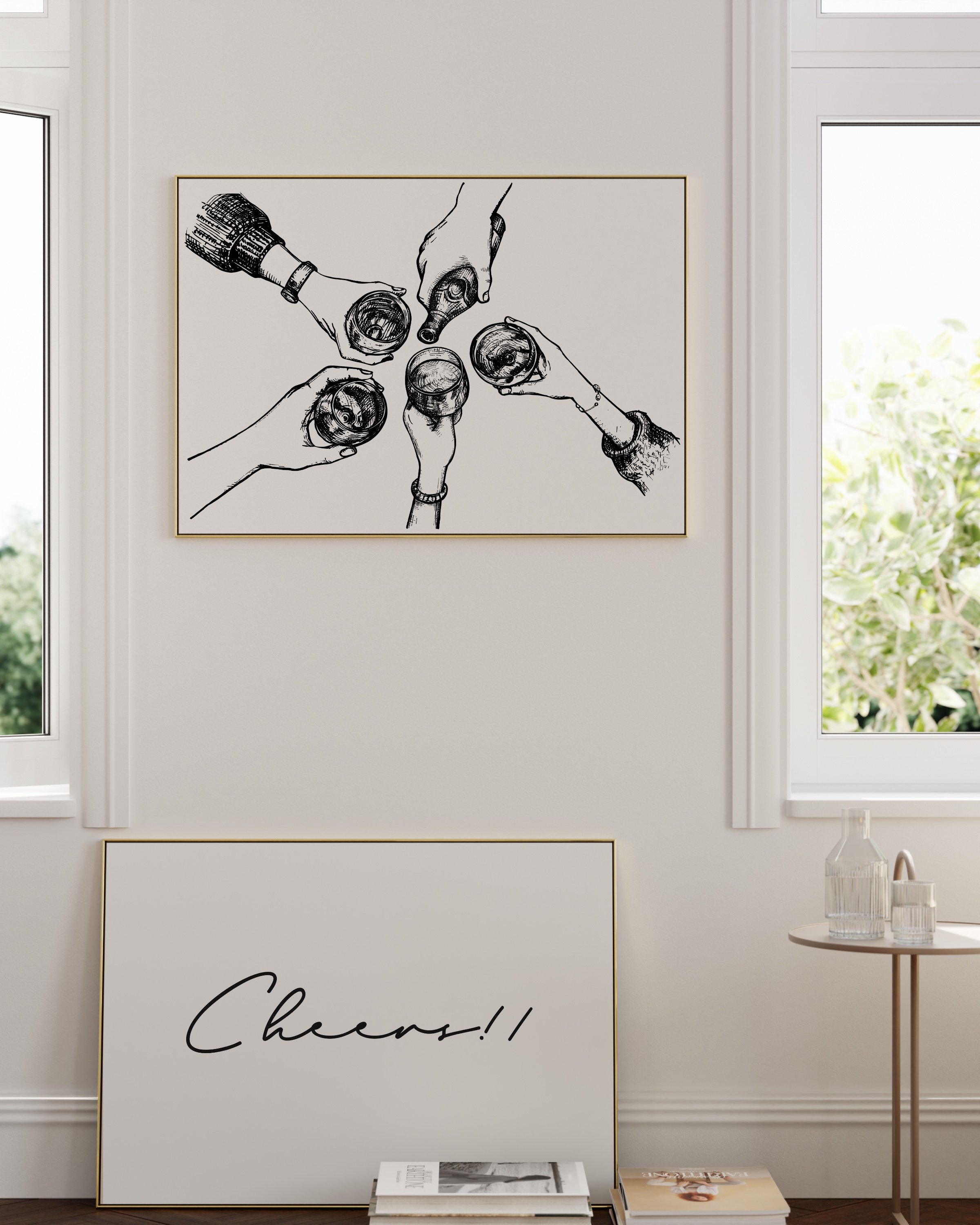 Minimalist black-and-white printable set featuring a ‘Cheers!!’ script and a hand-drawn toast scene, displayed in sleek white frames on a neutral wall.