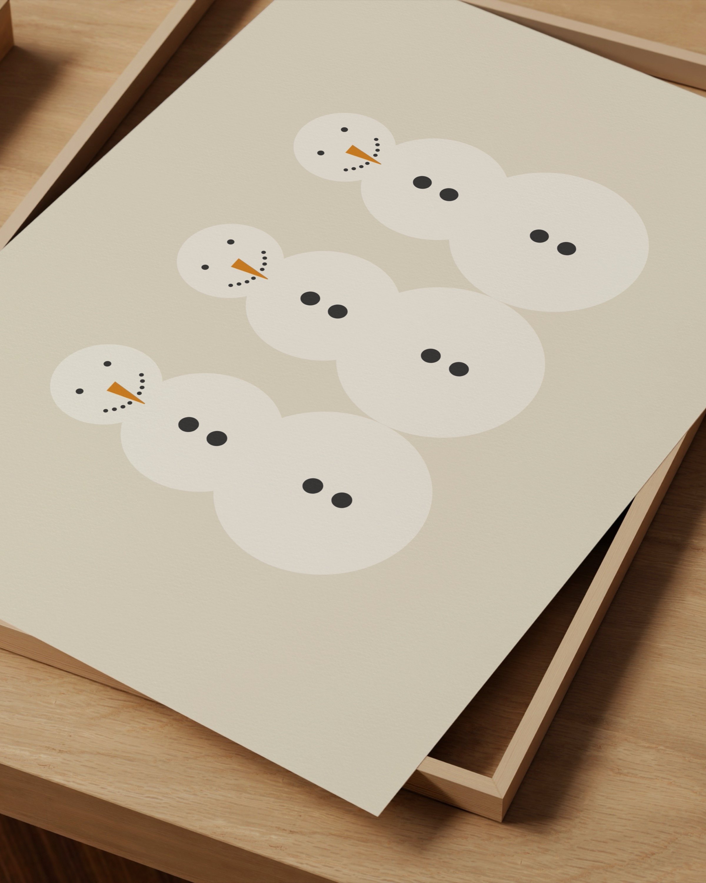 Minimalist snowman art print featuring three snowmen with carrot noses and button details on a beige background.