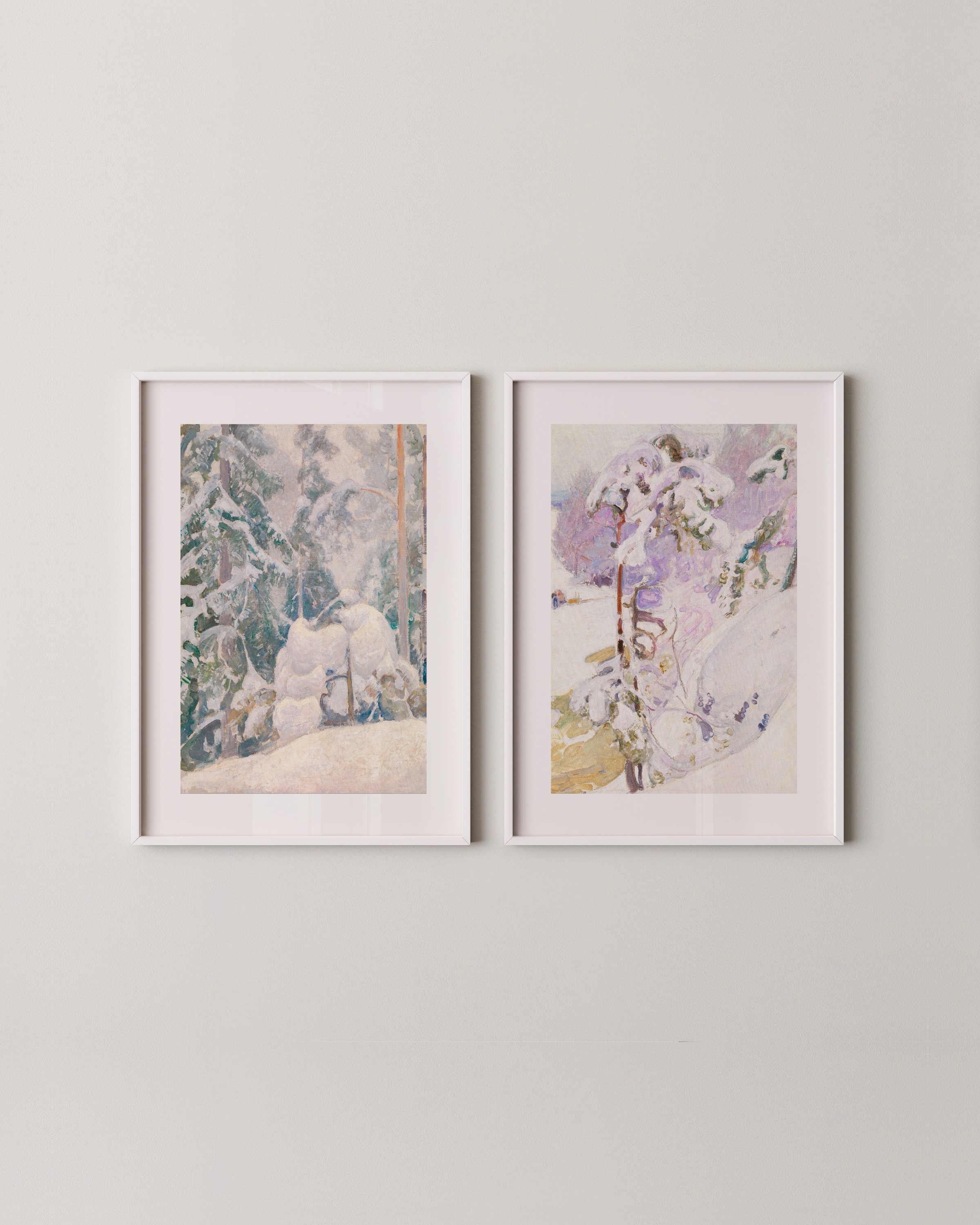 A two-piece winter wall art set featuring snowy forest landscapes in soft pastel tones, displayed in minimalist white frames.