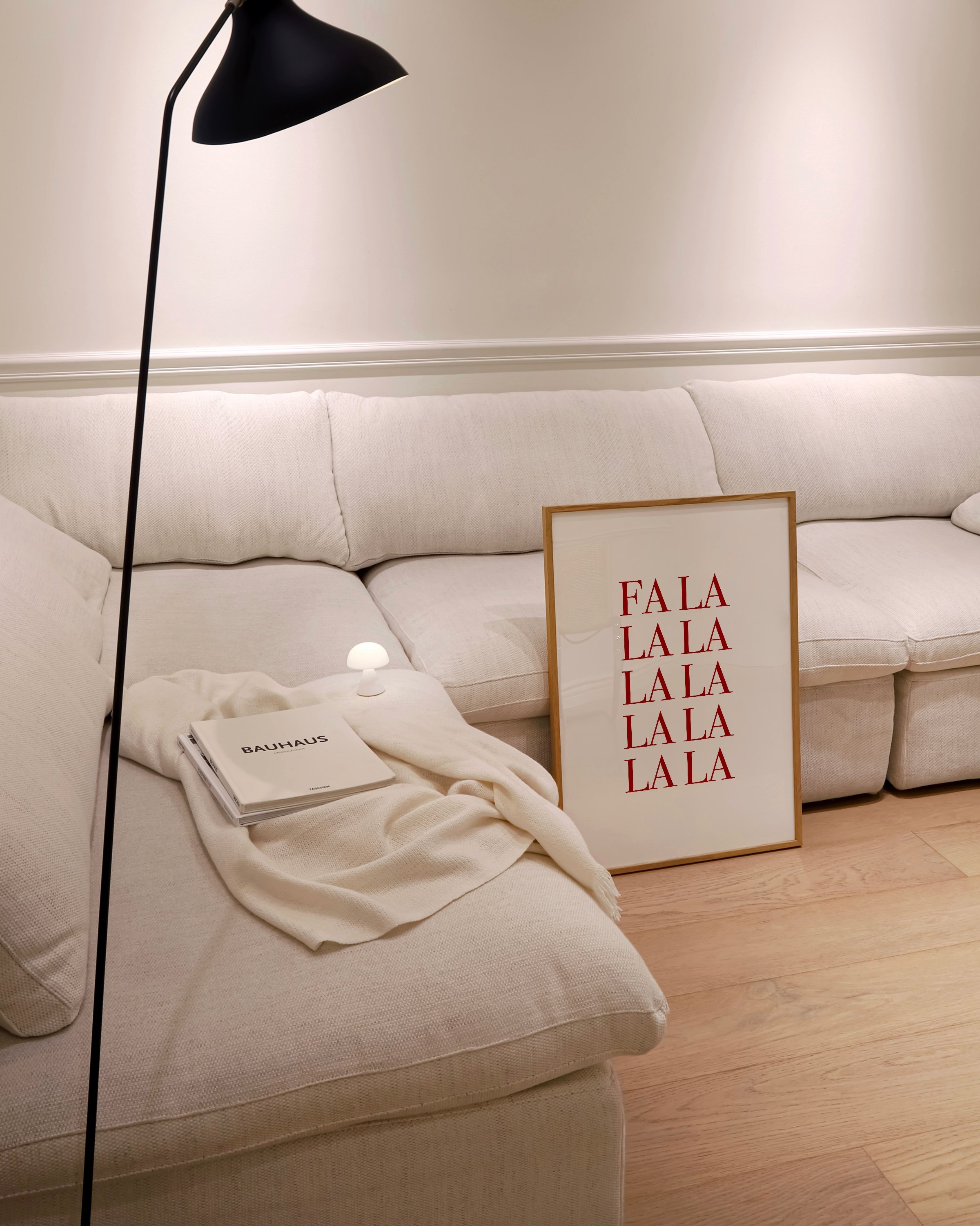 “Fa La La” in bold red typography stacked vertically on a white background, ideal for festive holiday decor.
