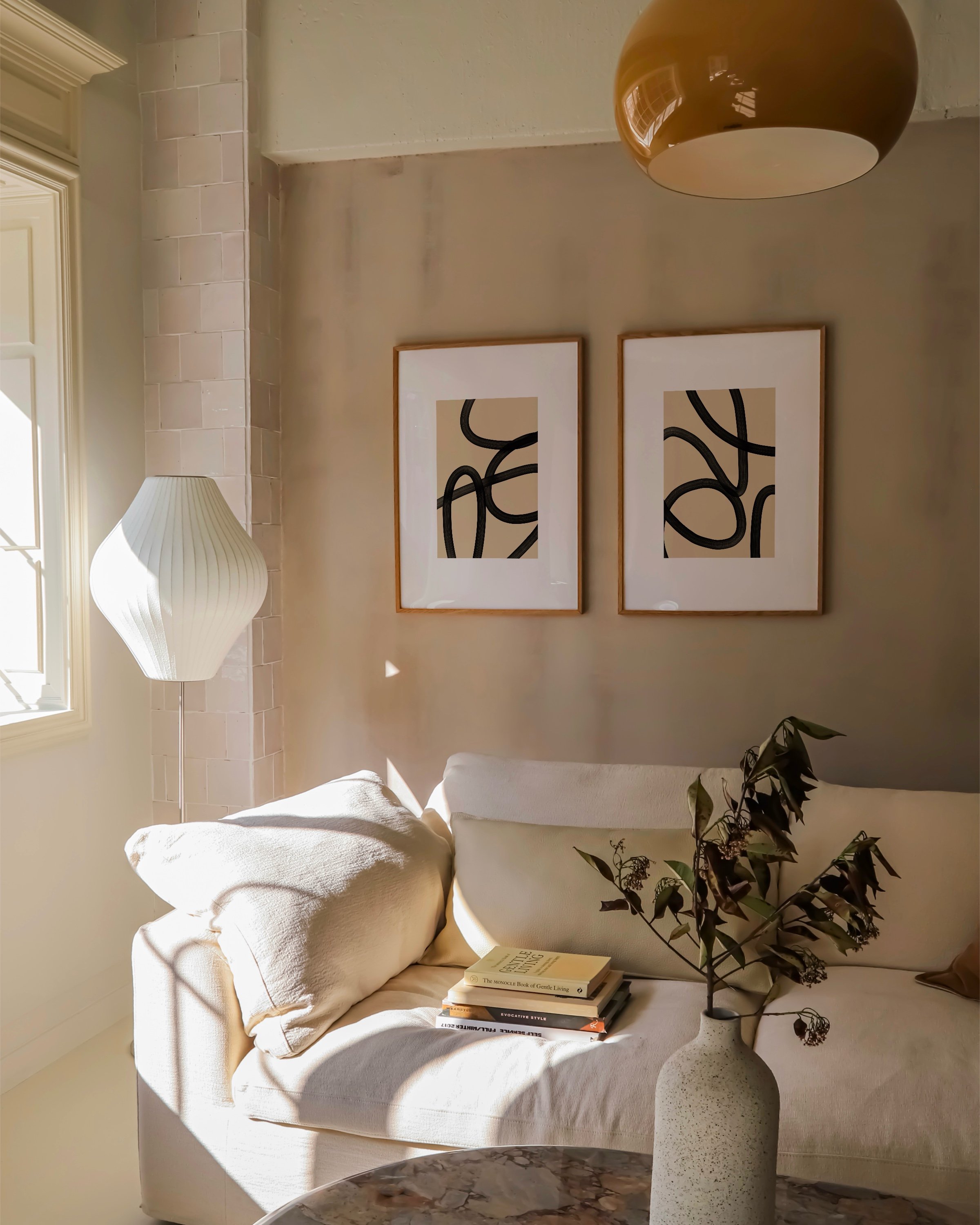 Set of two abstract black and beige line art prints featuring bold, flowing lines on a neutral background, ideal for modern and minimalist decor.