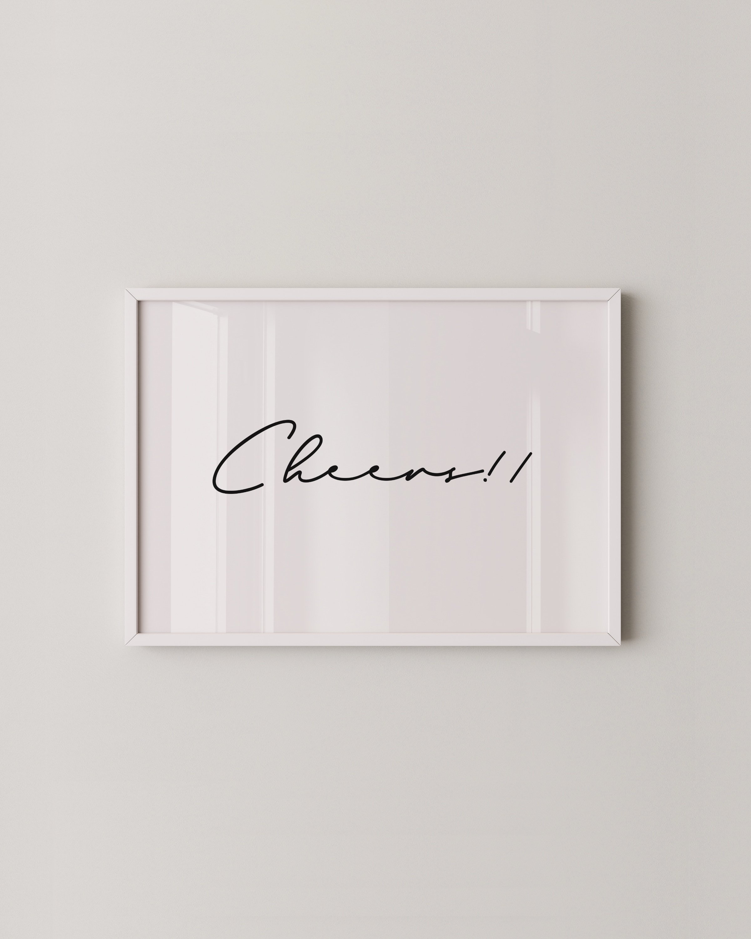 Minimalist black-and-white printable set featuring a ‘Cheers!!’ script and a hand-drawn toast scene, displayed in sleek white frames on a neutral wall.