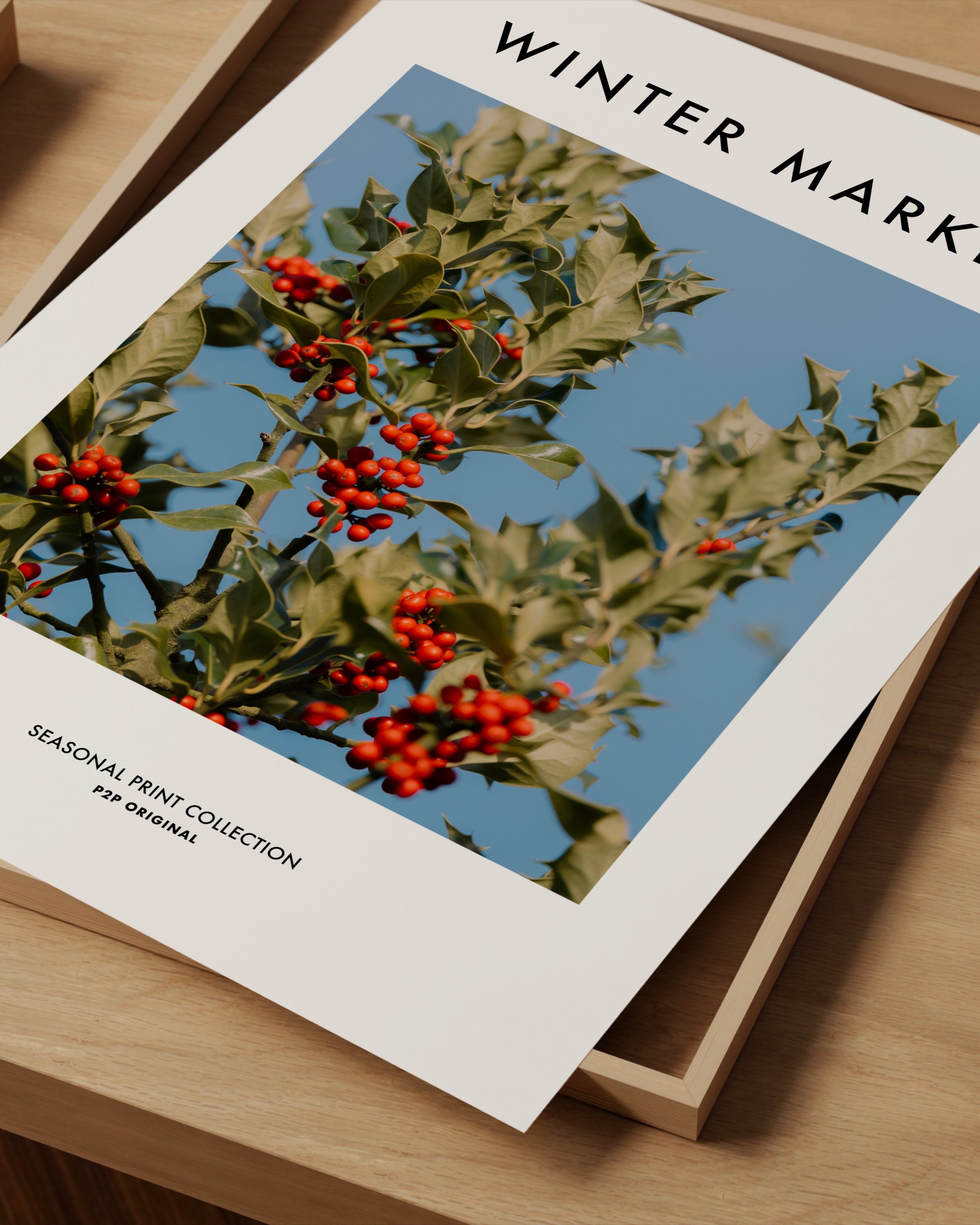 Vibrant photograph of red holly berries with green leaves set against a bright blue sky, perfect for festive holiday decor.