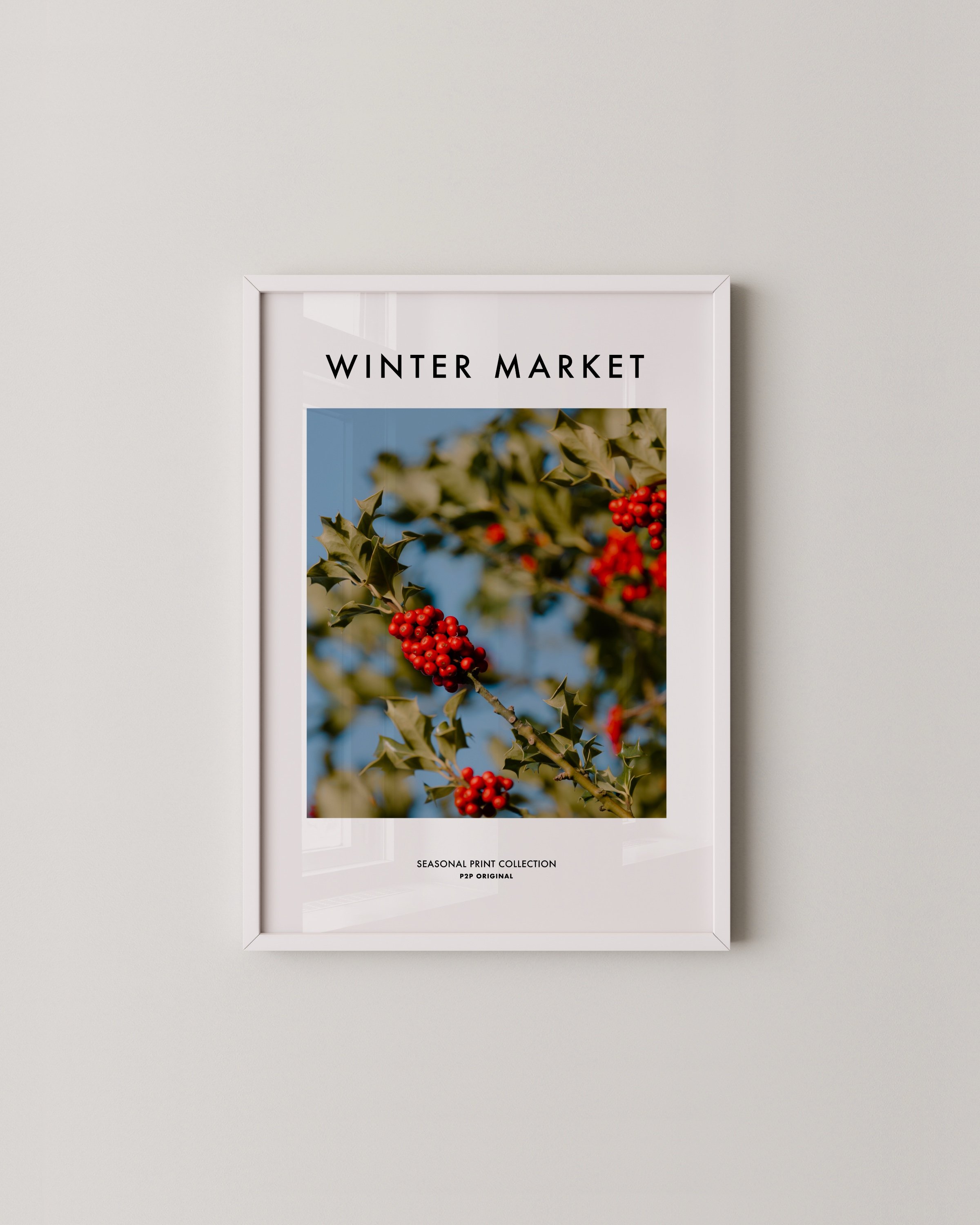 Vibrant photograph of red holly berries with green leaves set against a bright blue sky, perfect for festive holiday decor.