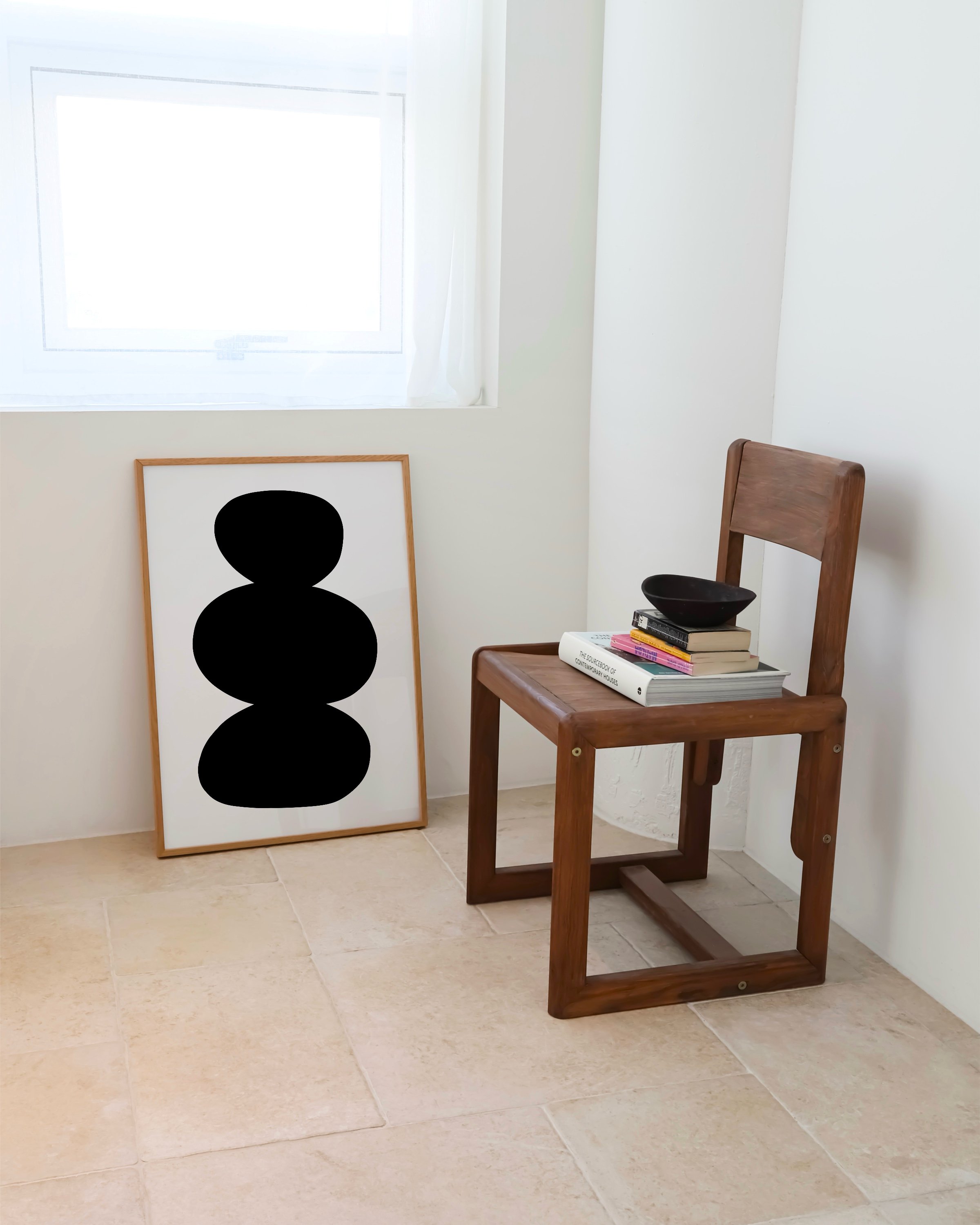 Minimalist abstract art featuring stacked organic black shapes on a light background, perfect for modern decor.