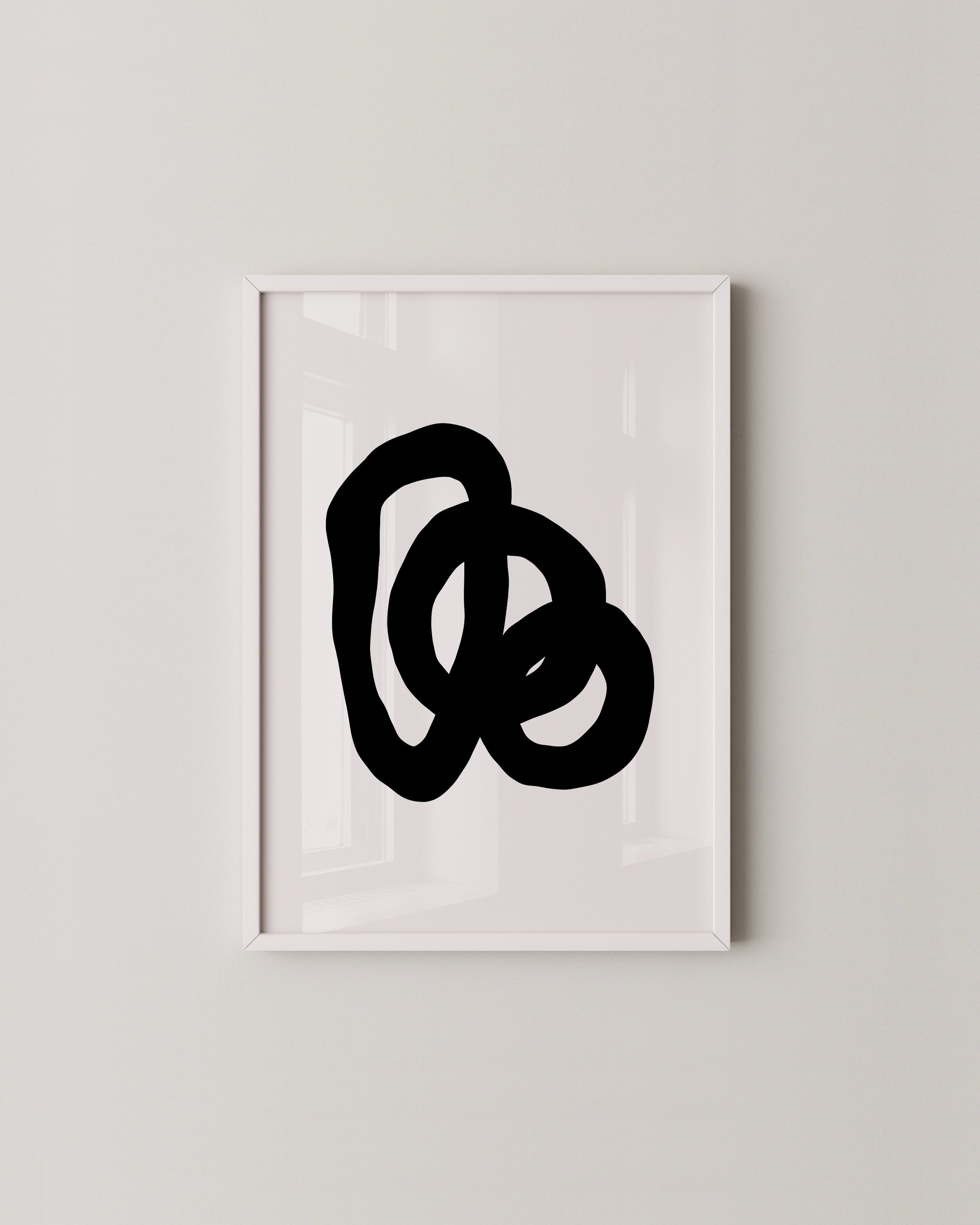 Minimalist abstract art prints featuring bold black loops on white backgrounds, framed in white and displayed as a contemporary art duo.