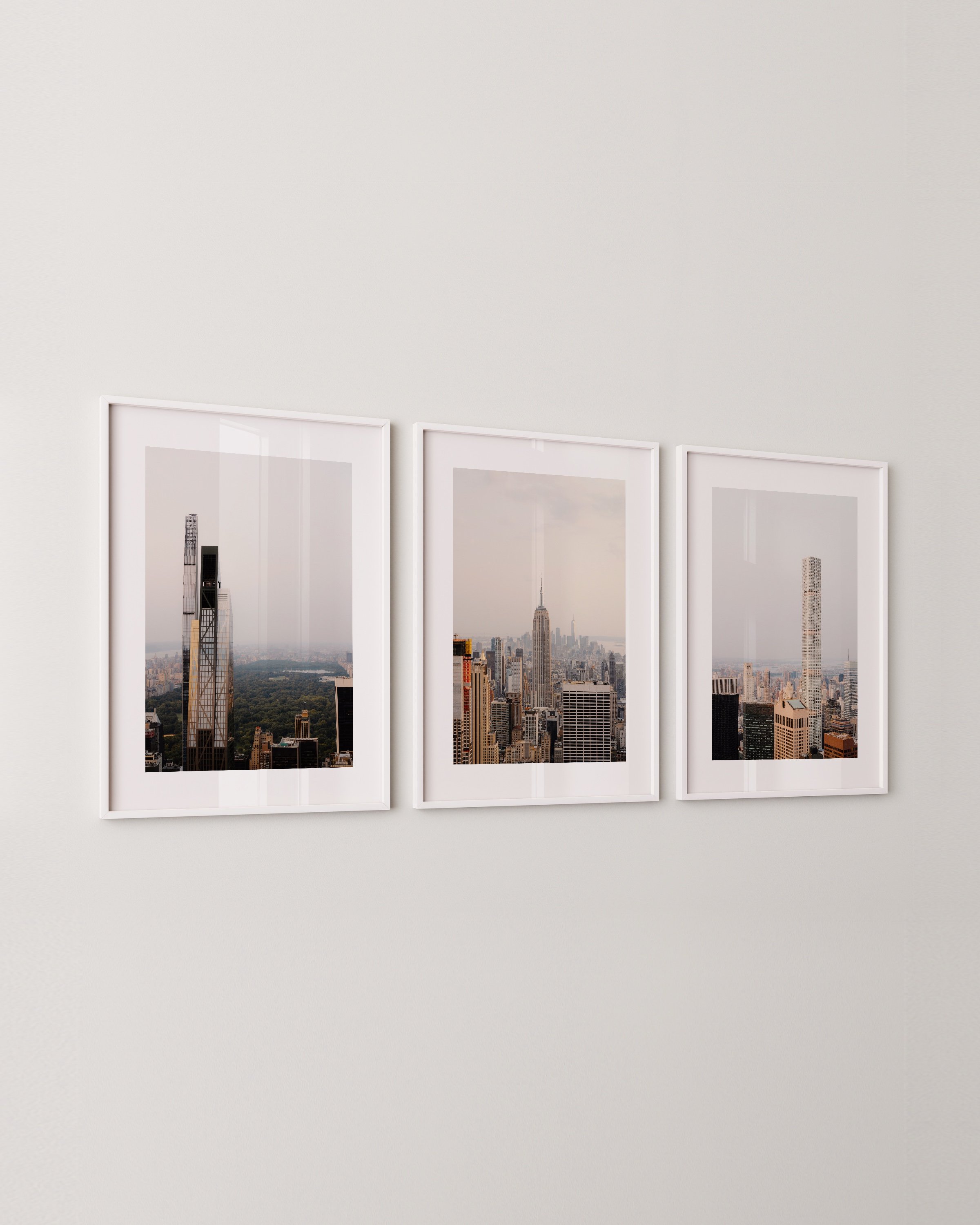 Set of three New York City skyline photography prints featuring iconic skyscrapers, including the Empire State Building and modern high-rises with views of Central Park.