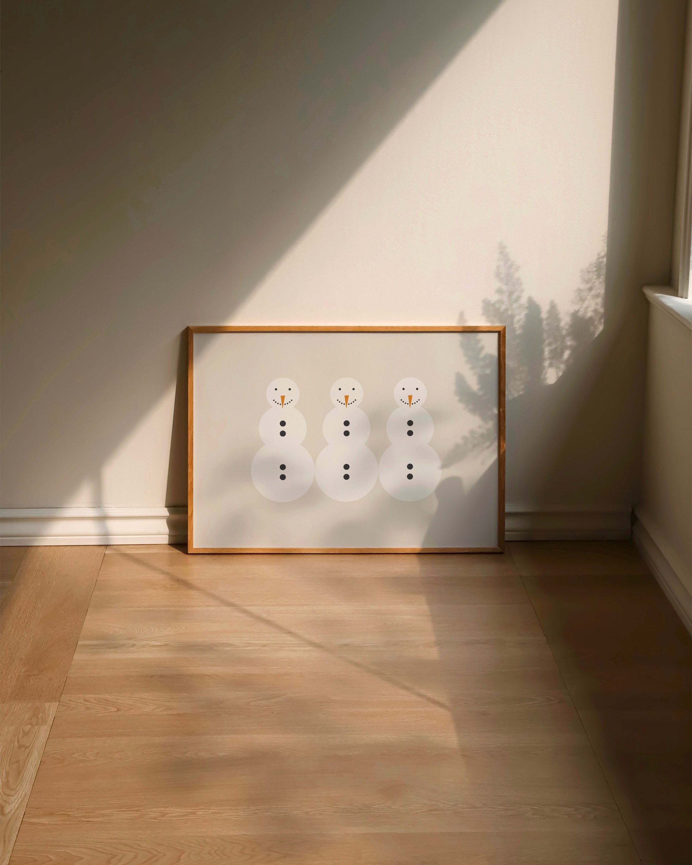 Minimalist snowman art print featuring three snowmen with carrot noses and button details on a beige background.