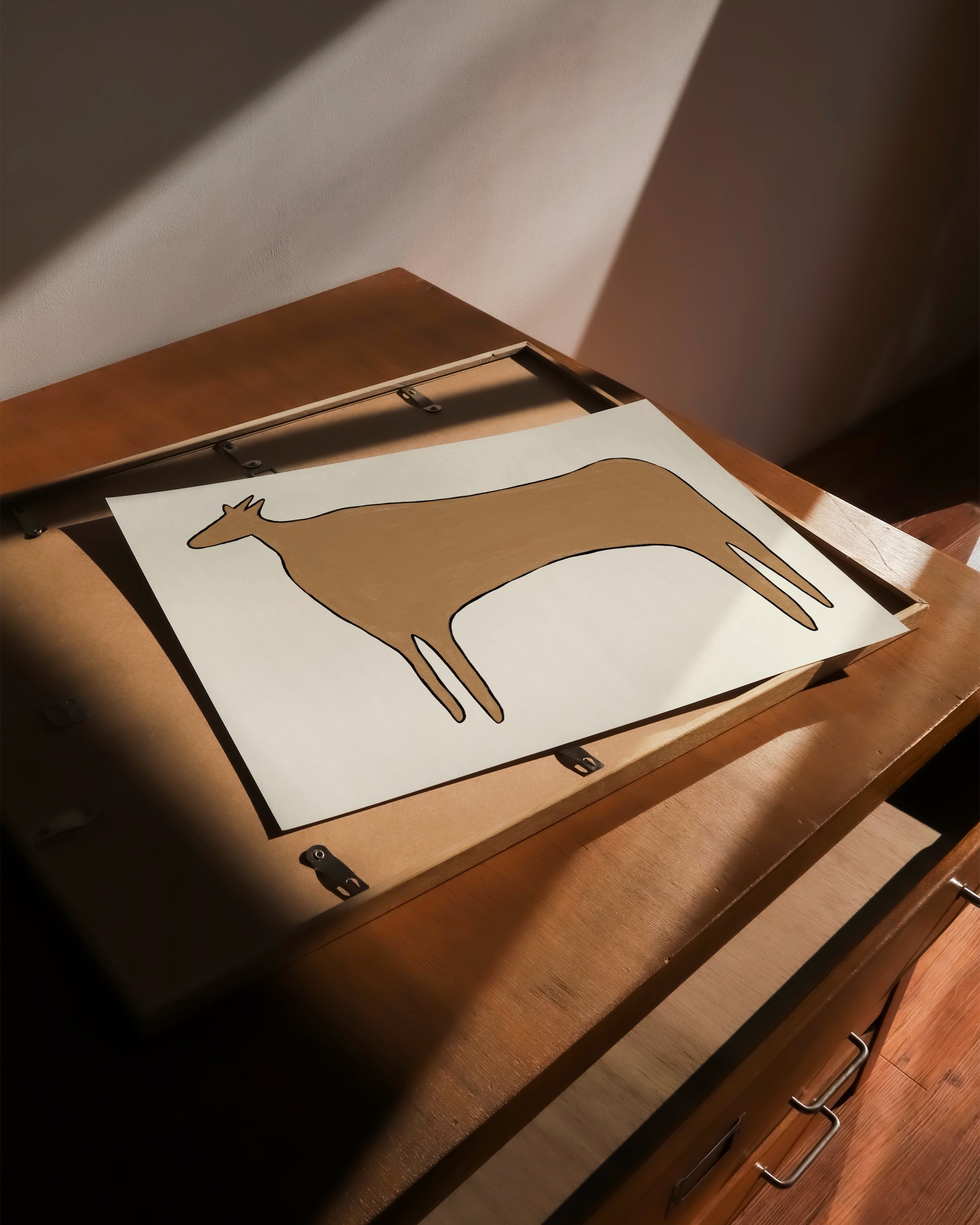 Minimalist illustration of a cow in warm, earthy tones, perfect for decorating a kids’ room or nursery.