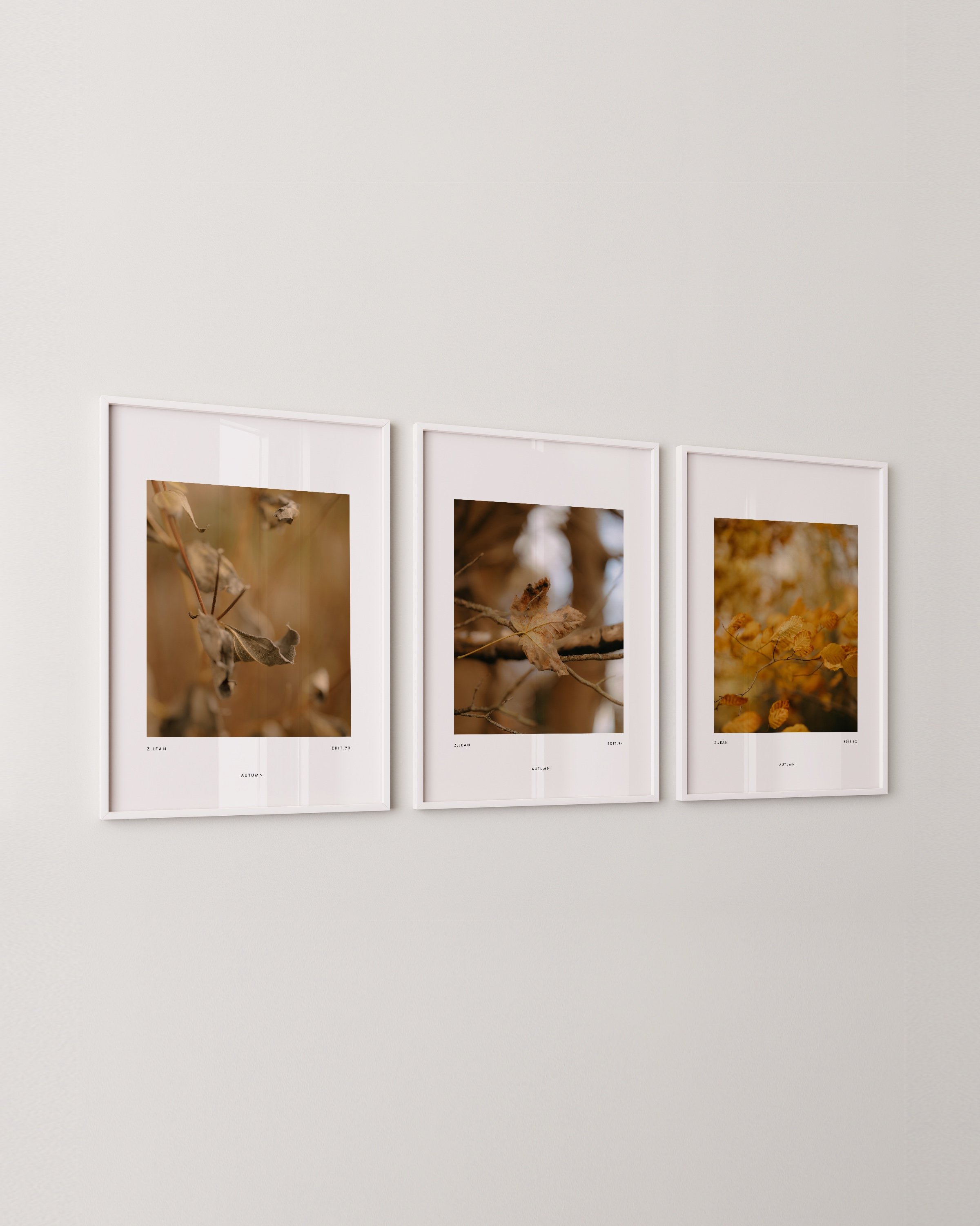 Set of three minimalist autumn wall art prints featuring close-up photography of golden and brown leaves in a warm and earthy color palette.
