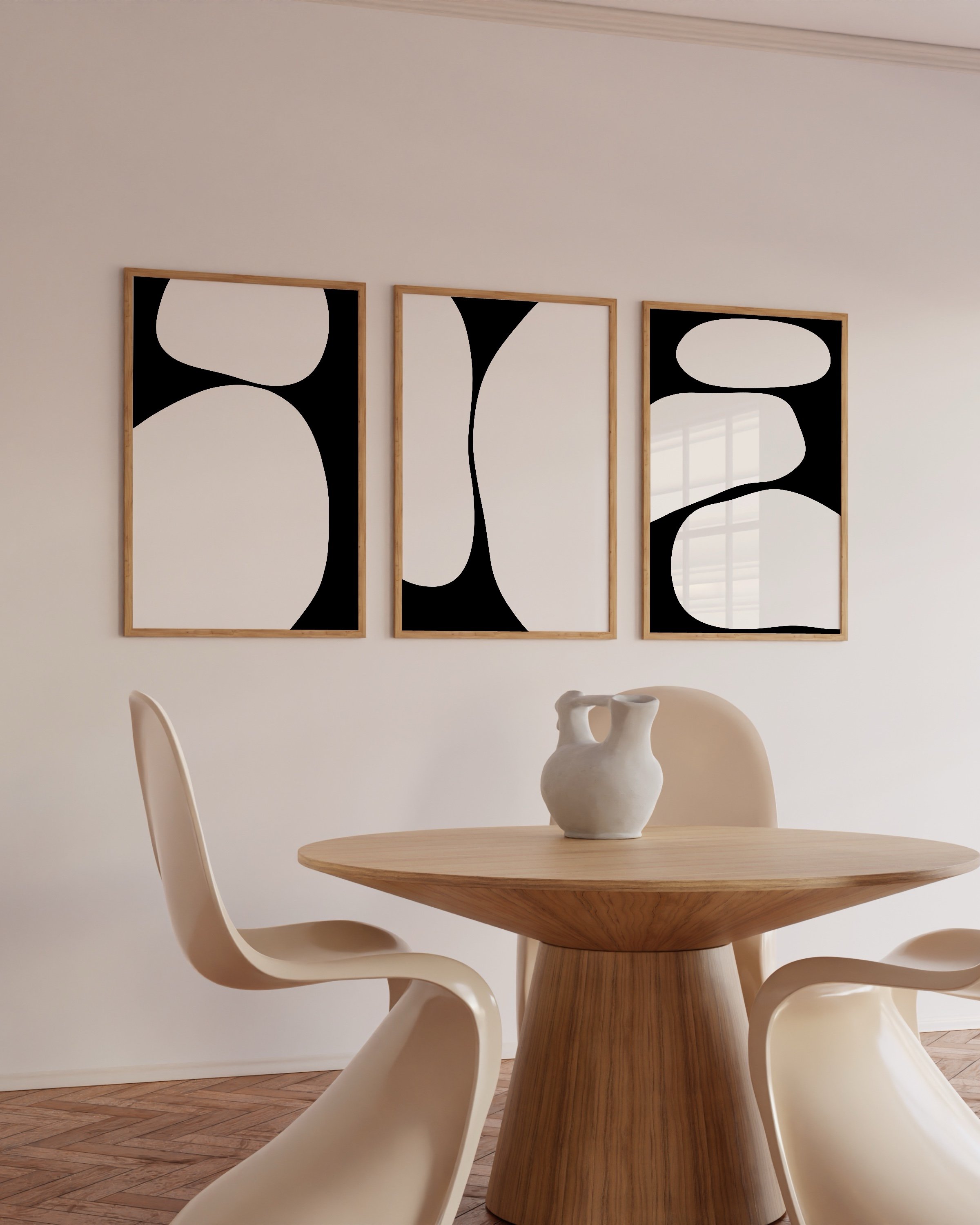A set of three abstract black and white art prints featuring bold, minimalist shapes in a cohesive triptych design.