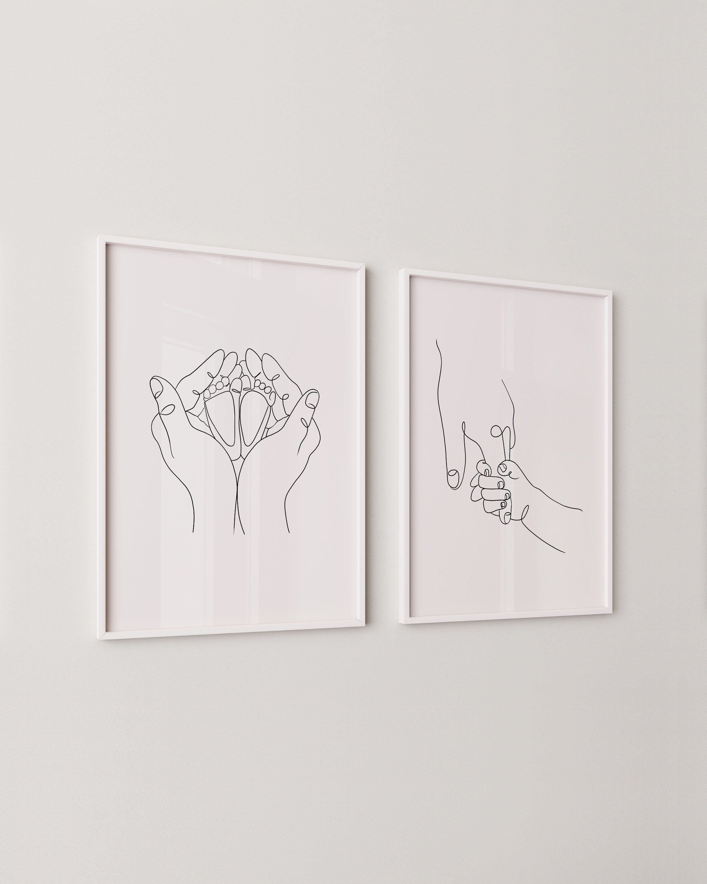 Minimalist line art print set featuring a parent’s hand holding a baby’s hand and hands cradling baby feet, perfect for modern nursery decor.