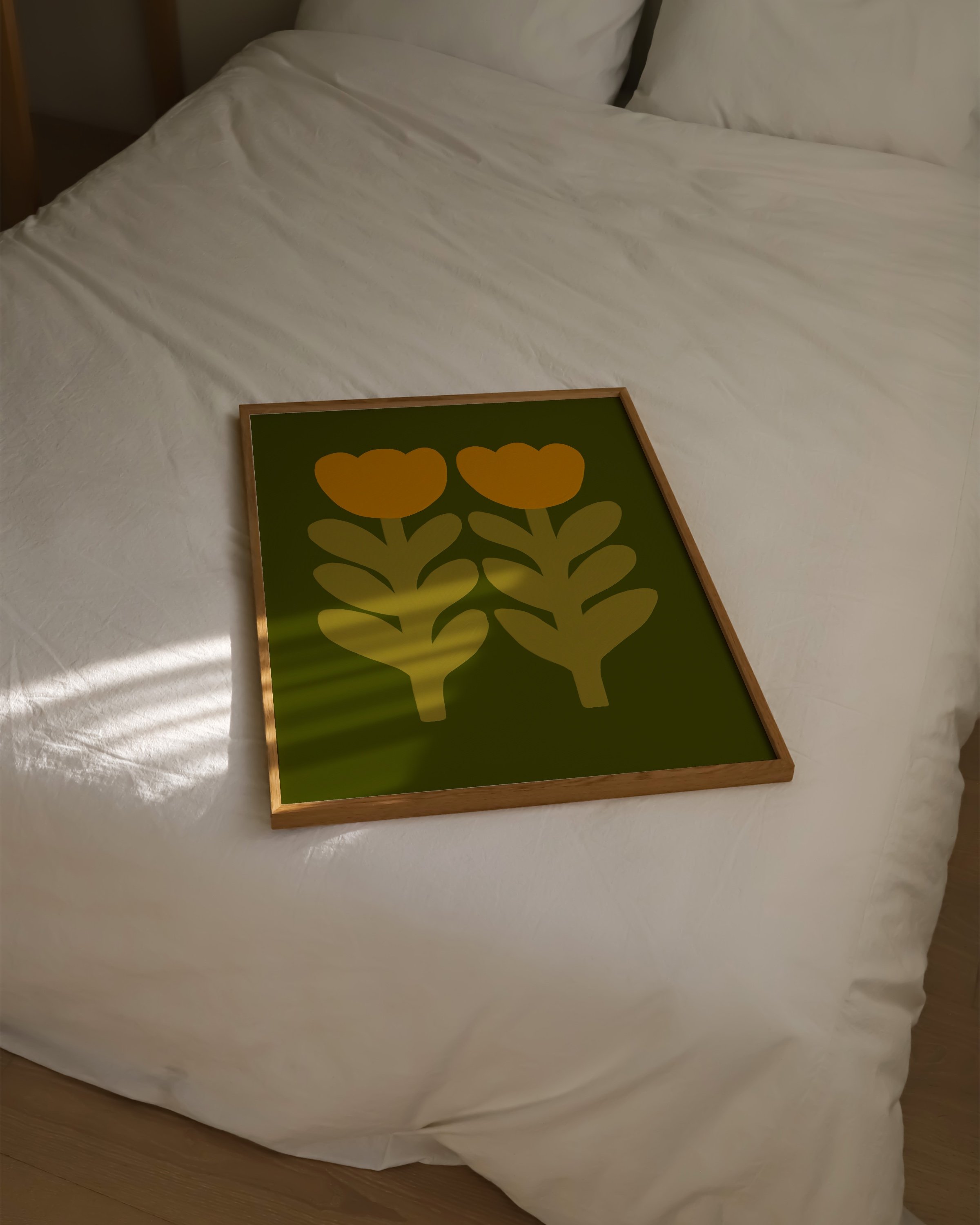 Print of two stylized mustard yellow tulips with leafy stems on an olive green background.