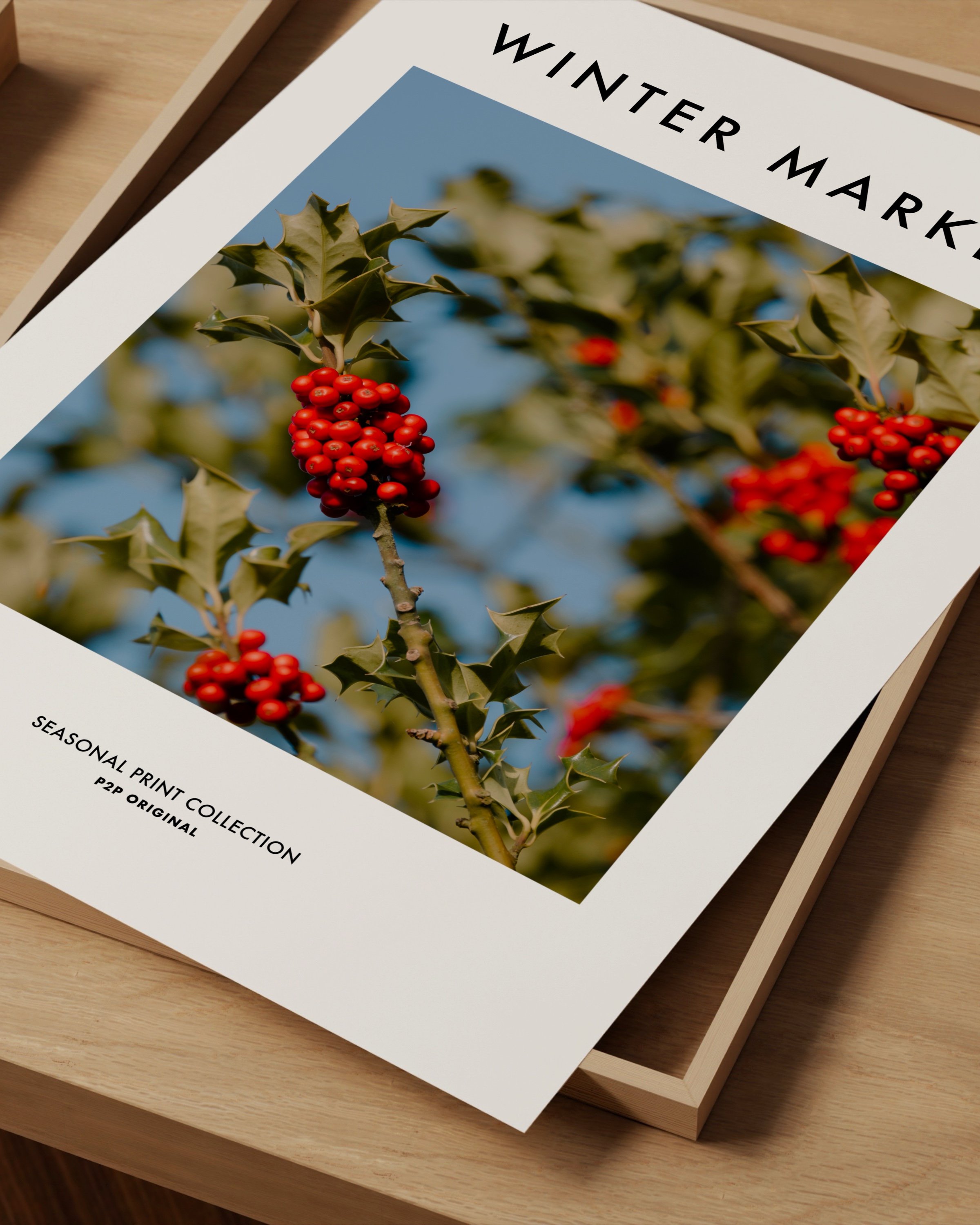 Vibrant photograph of red holly berries with green leaves set against a bright blue sky, perfect for festive holiday decor.