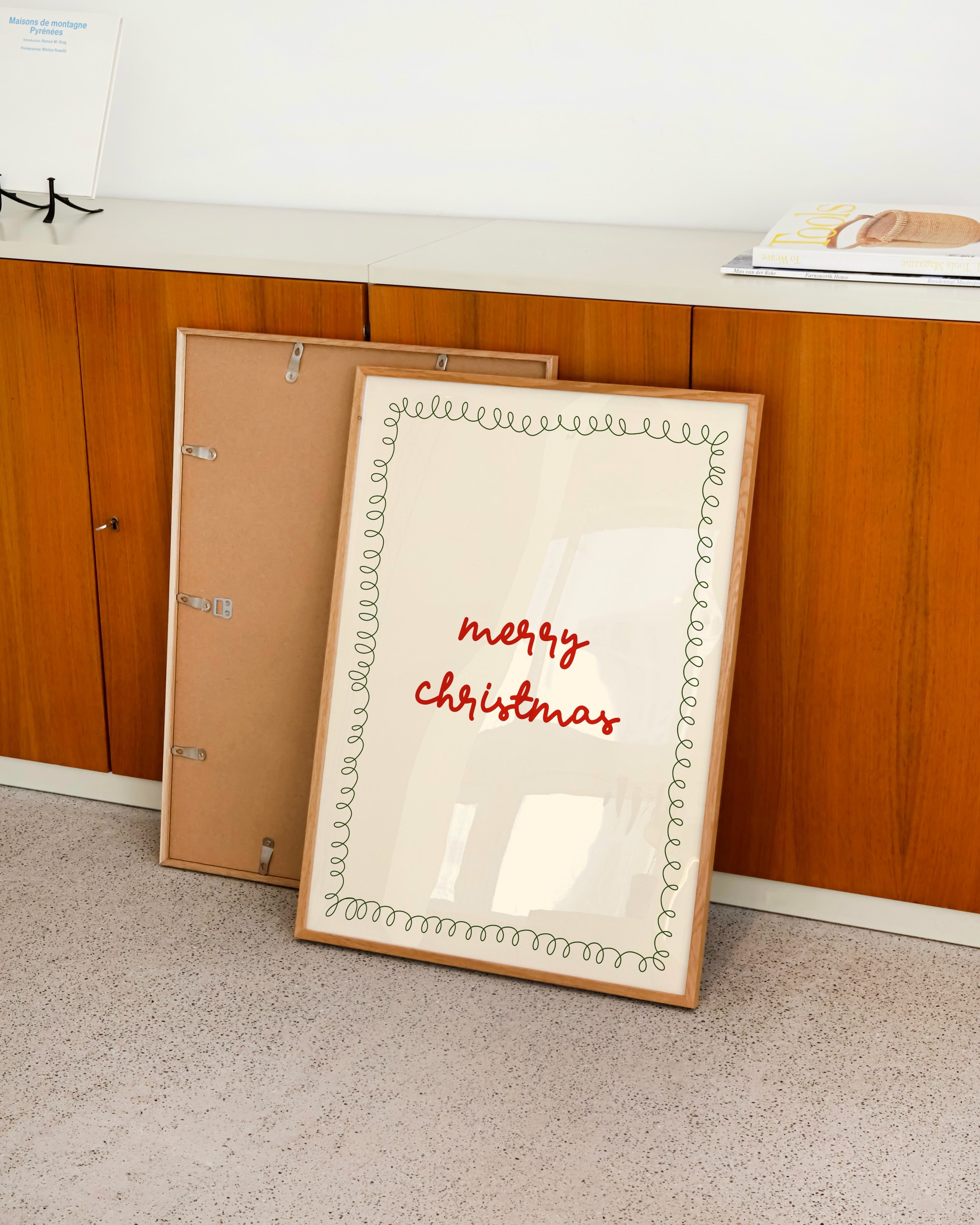 Minimalist Christmas printable art with red ‘Merry Christmas’ text in a handwritten style, framed by a green squiggle border on a beige background.