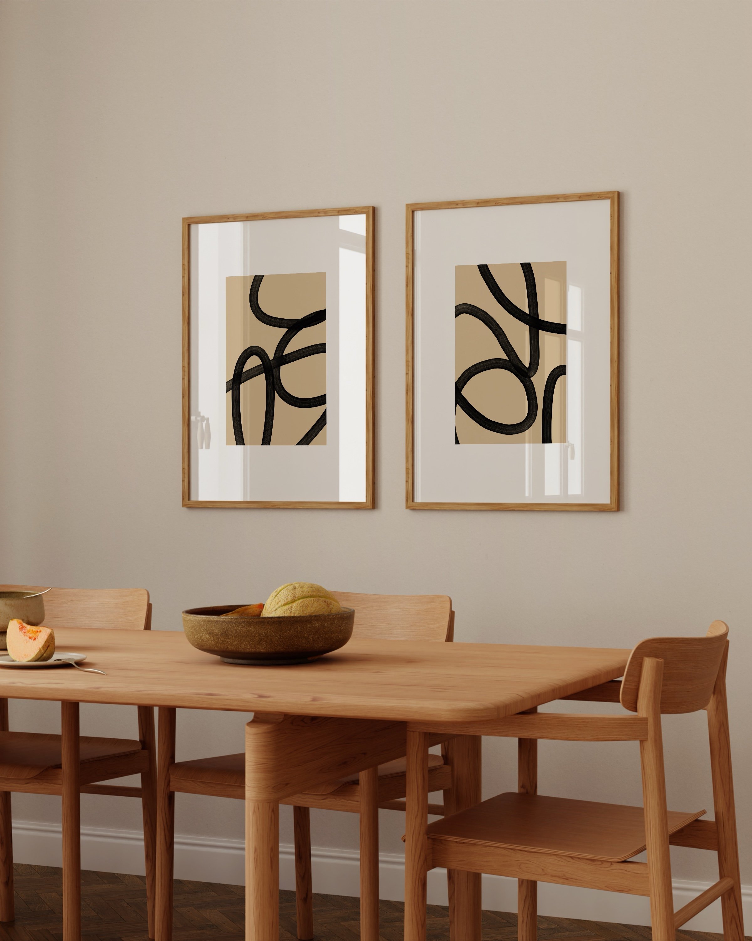 Set of two abstract black and beige line art prints featuring bold, flowing lines on a neutral background, ideal for modern and minimalist decor.
