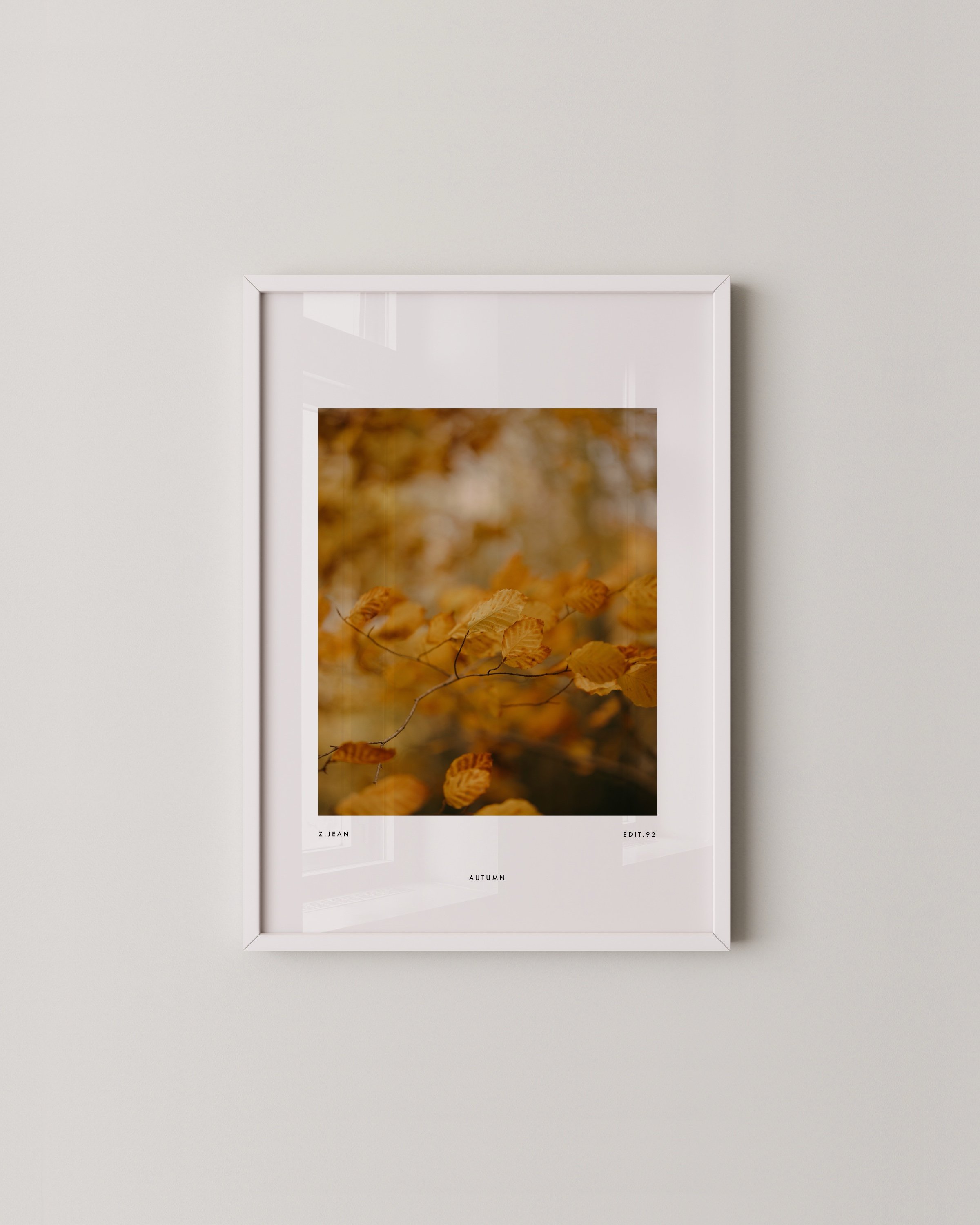 Set of three minimalist autumn wall art prints featuring close-up photography of golden and brown leaves in a warm and earthy color palette.