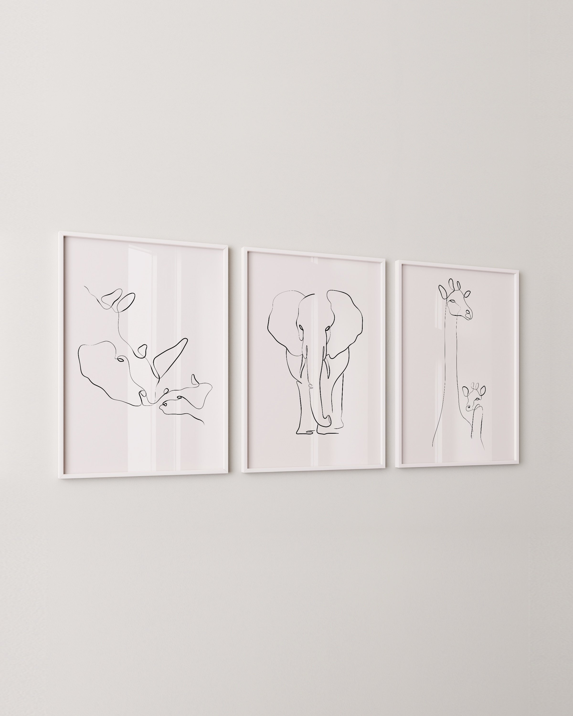 Minimalist black-and-white animal line art prints featuring an elephant, giraffe, and rhino, perfect for adding a modern touch to any space.