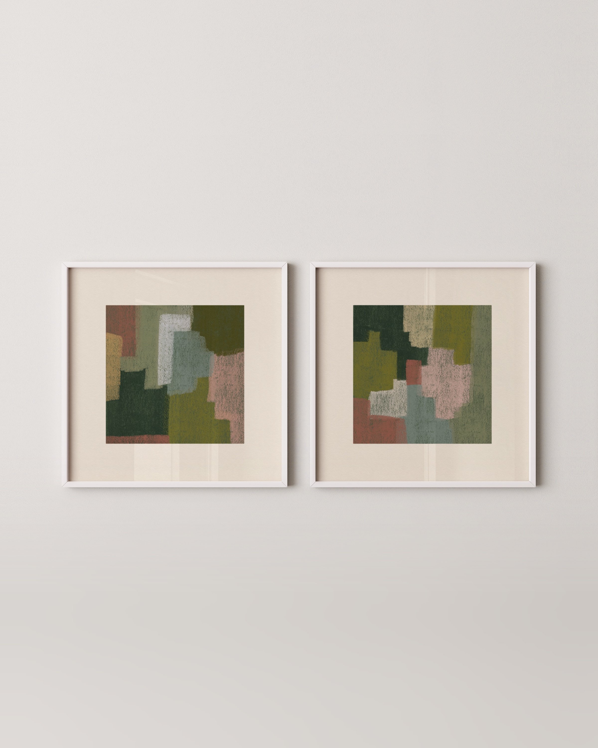 Set of two abstract wall art prints in earthy tones, displayed above a green sofa in a cozy living room.