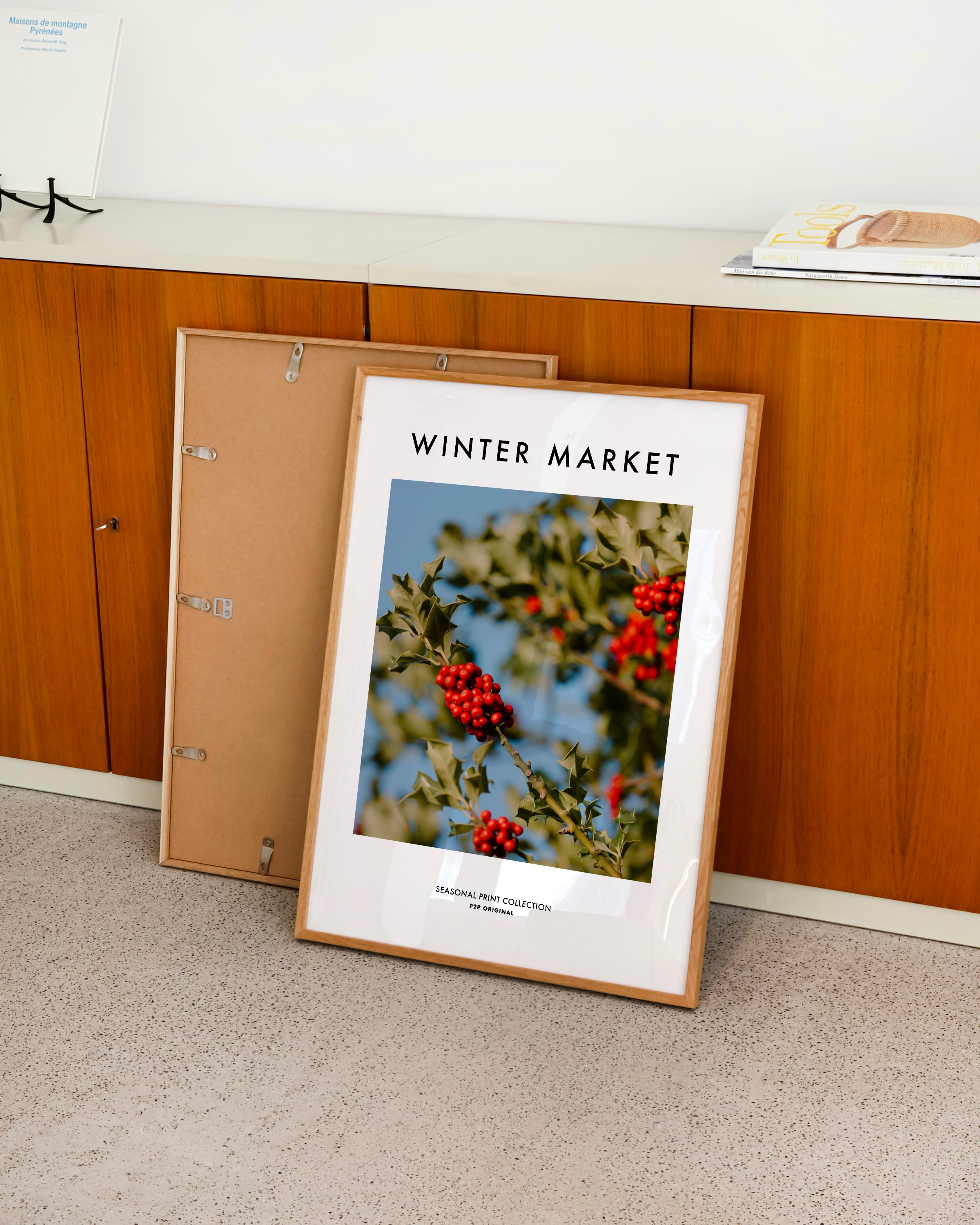 Vibrant photograph of red holly berries with green leaves set against a bright blue sky, perfect for festive holiday decor.