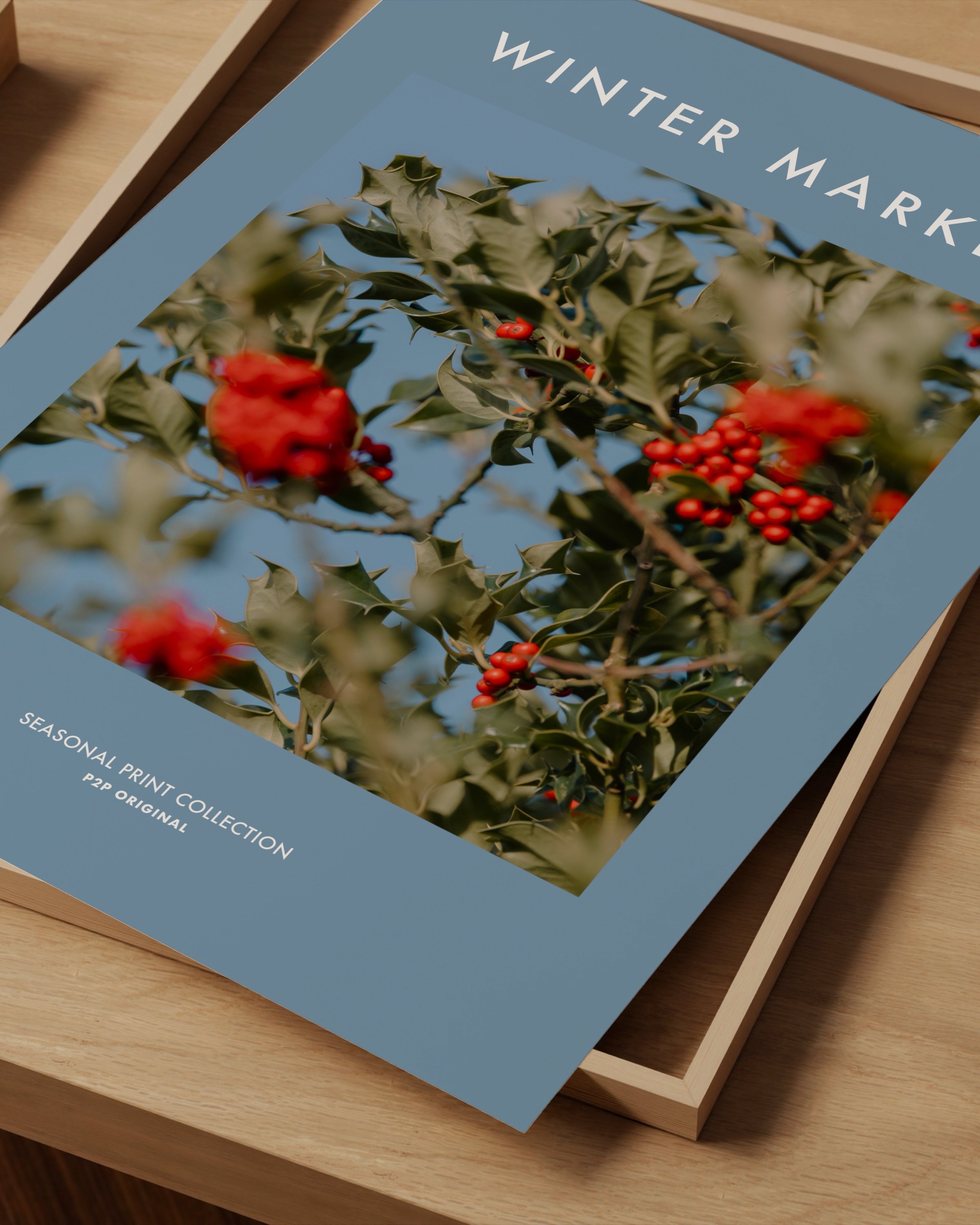 Winter Market seasonal printable wall art featuring a vibrant photo of holly berries with green leaves on a soft blue background.