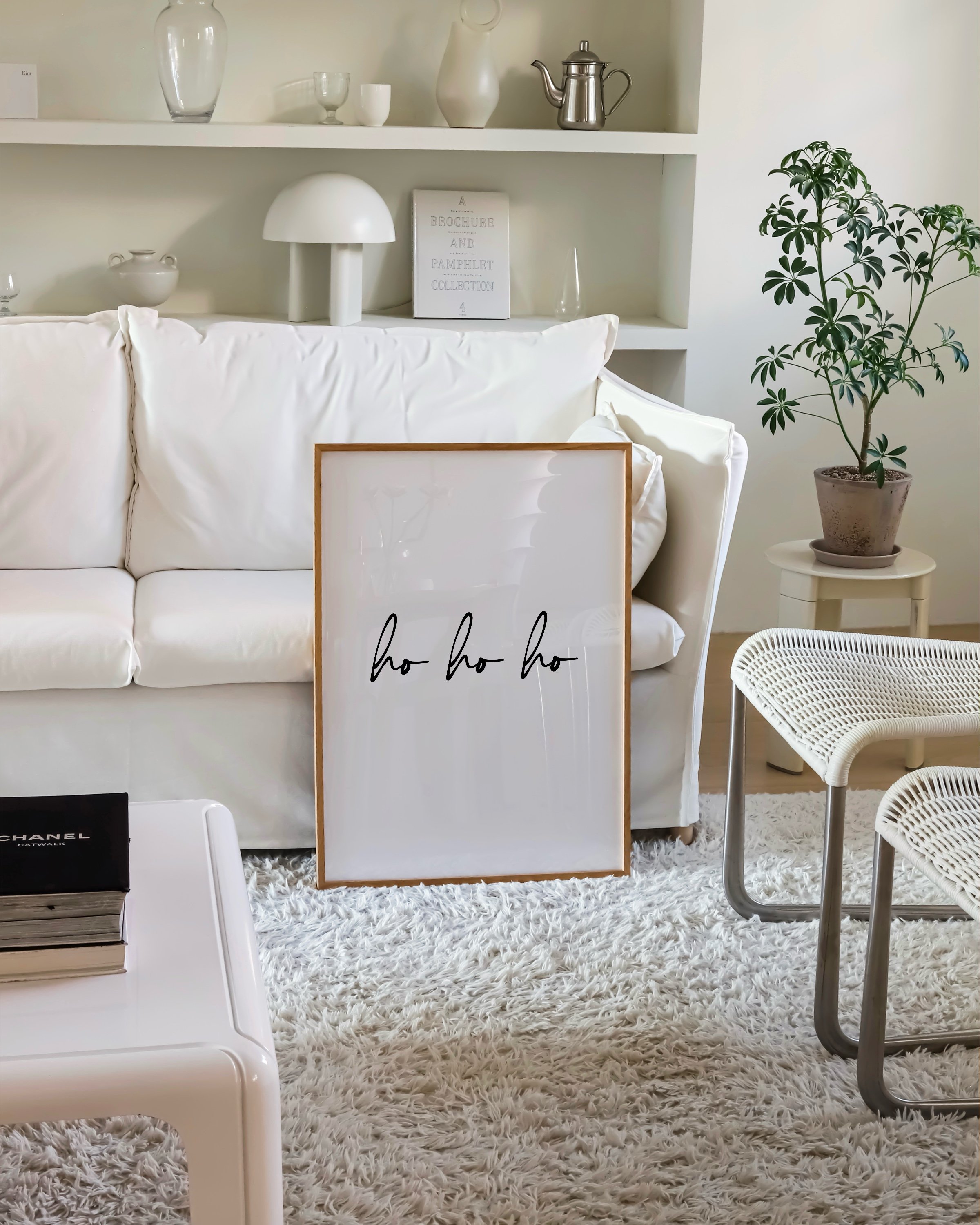 Minimalist “Ho Ho Ho” art print in black script on a white background, perfect for holiday decor.