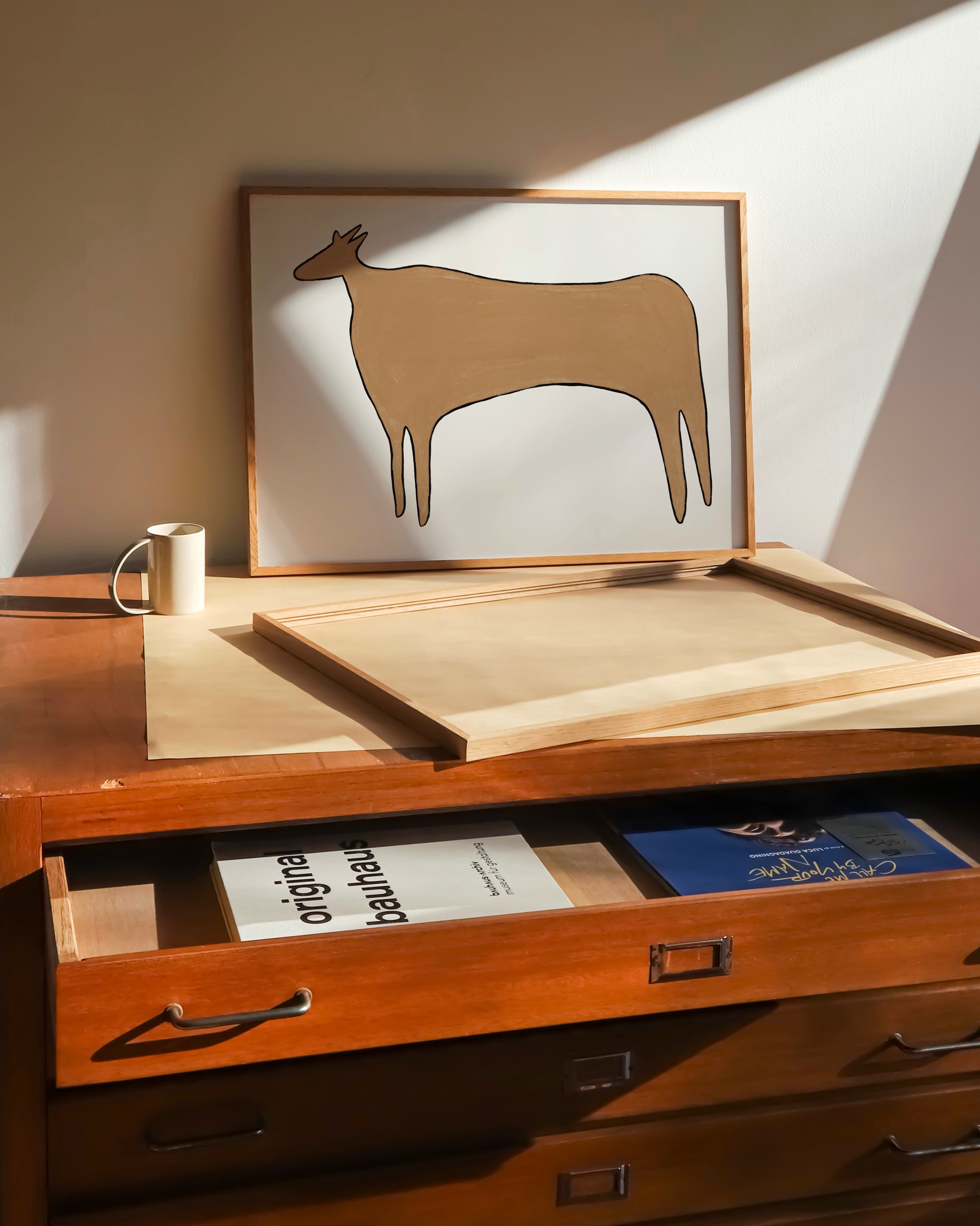 Minimalist illustration of a cow in warm, earthy tones, perfect for decorating a kids’ room or nursery.