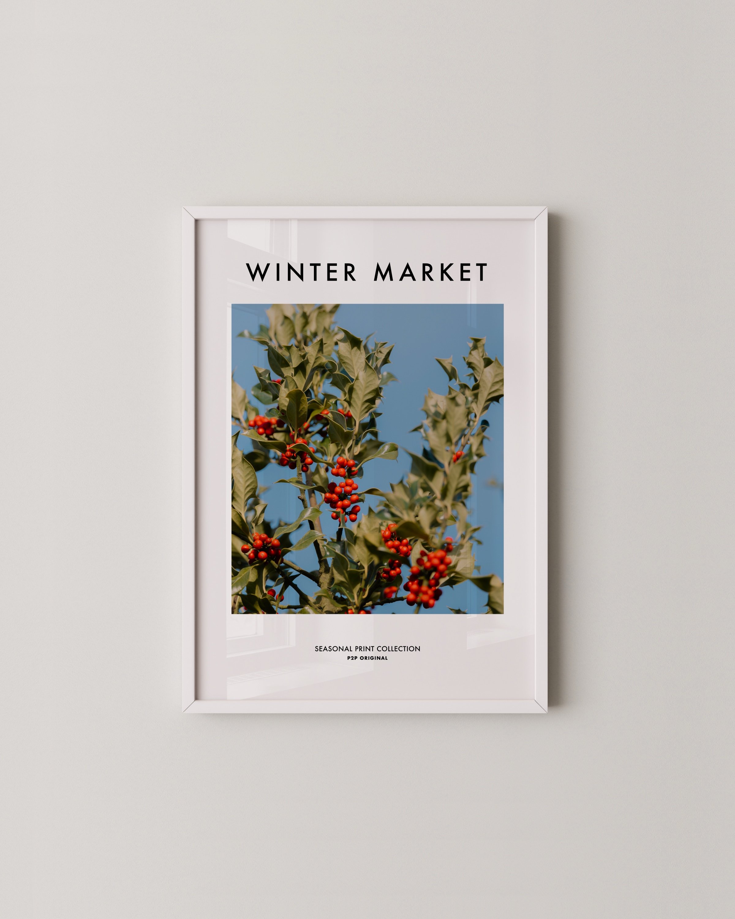 Vibrant photograph of red holly berries with green leaves set against a bright blue sky, perfect for festive holiday decor.