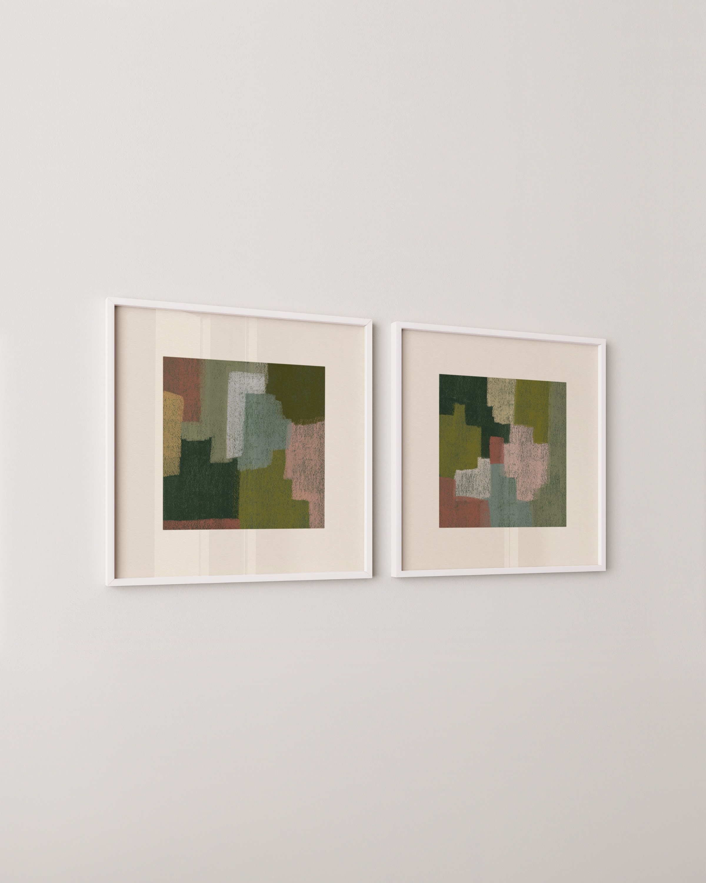 Set of two abstract wall art prints in earthy tones, displayed above a green sofa in a cozy living room.