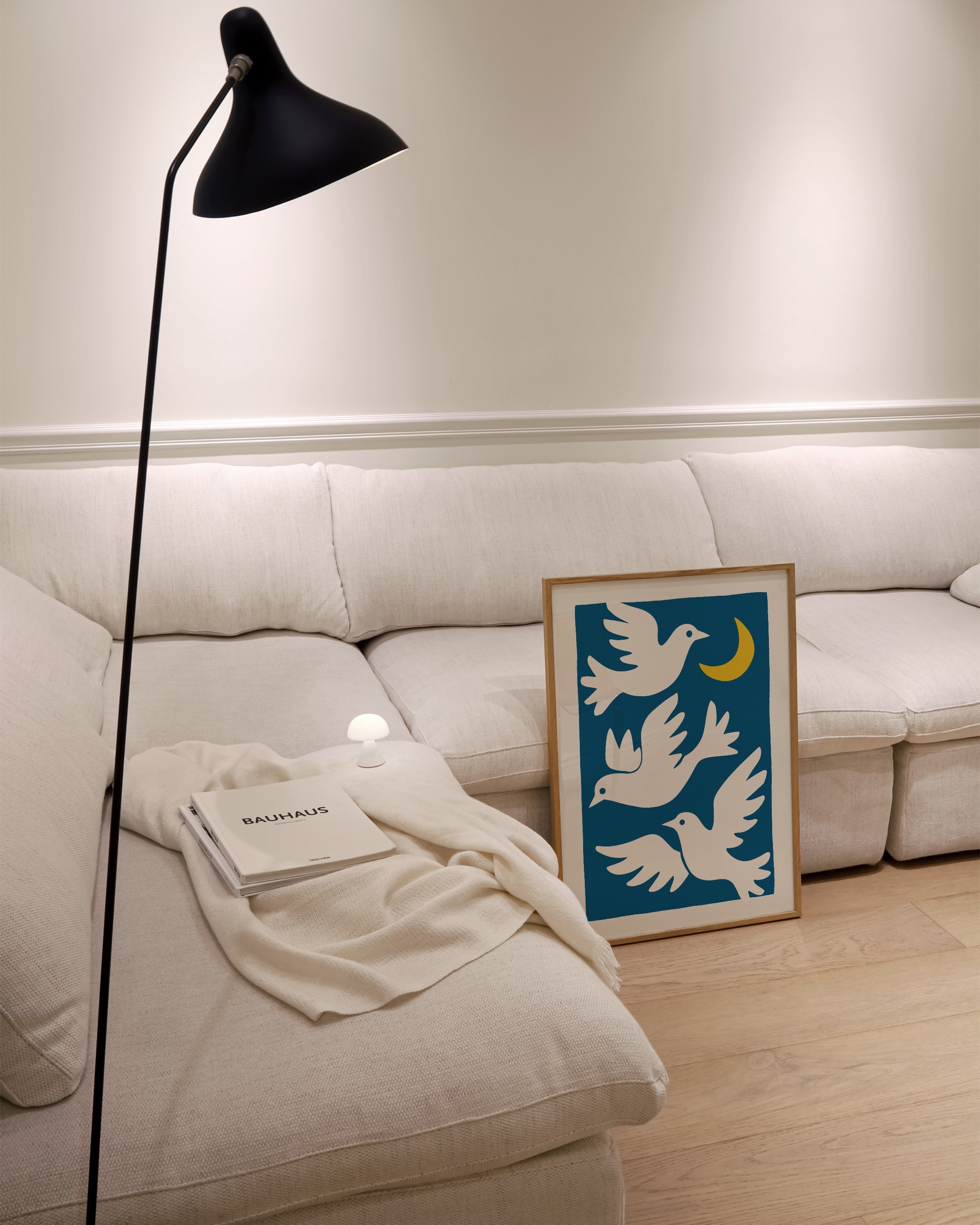 featuring three white doves flying around a yellow crescent moon on a bold blue background.
