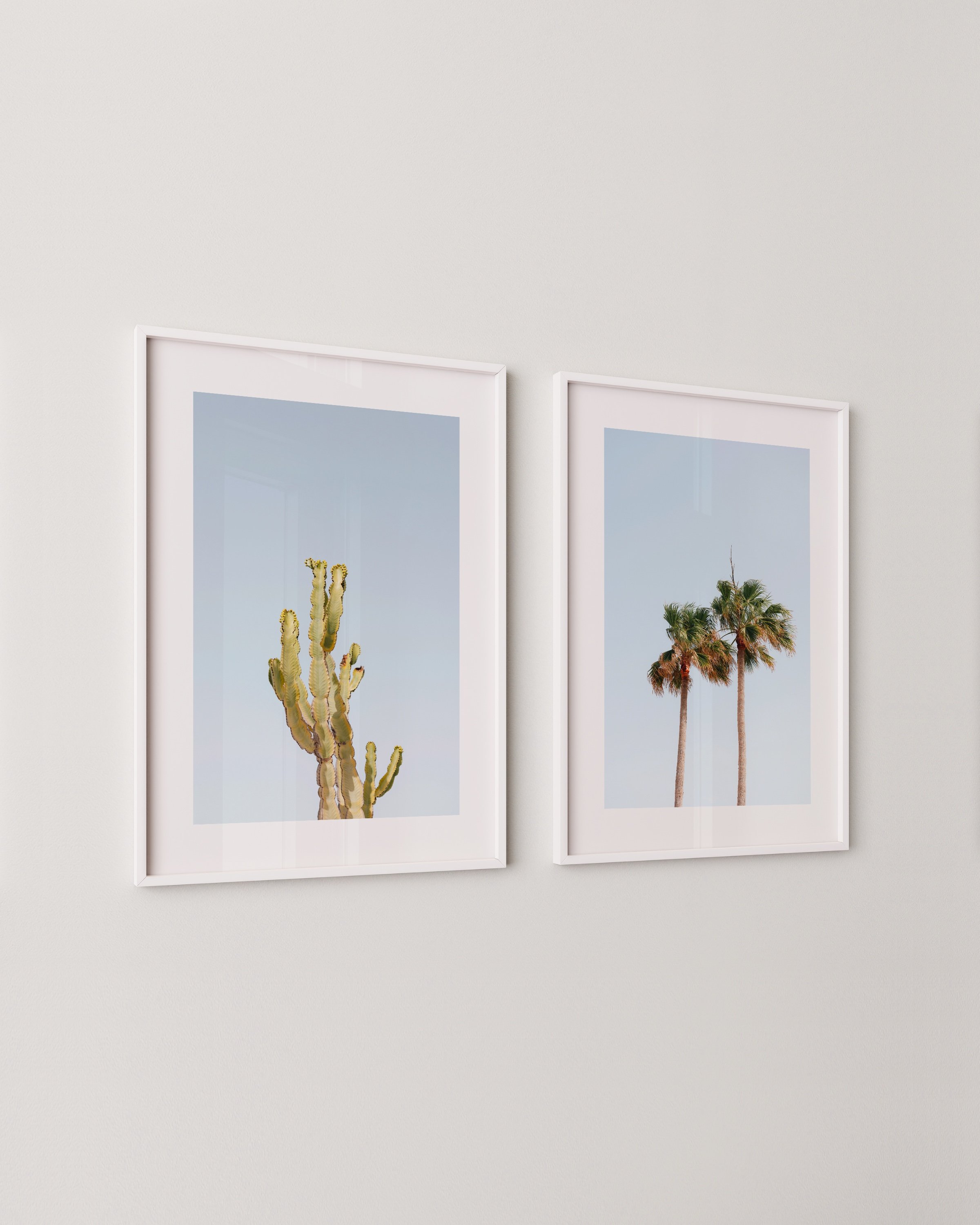 Set of three desert-themed wall art prints featuring cacti, palm trees, and minimalist architecture under a bright blue sky.