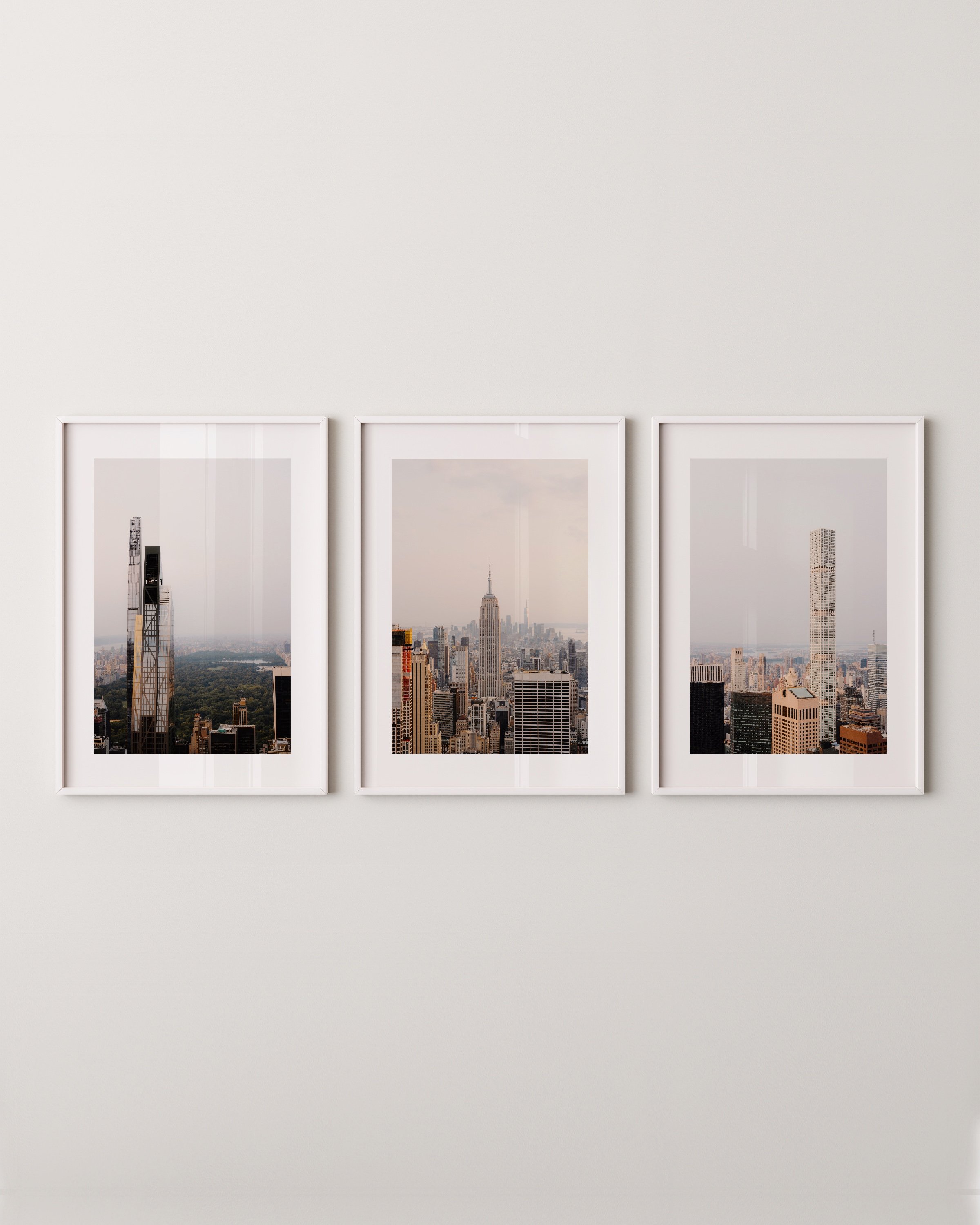 Set of three New York City skyline photography prints featuring iconic skyscrapers, including the Empire State Building and modern high-rises with views of Central Park.