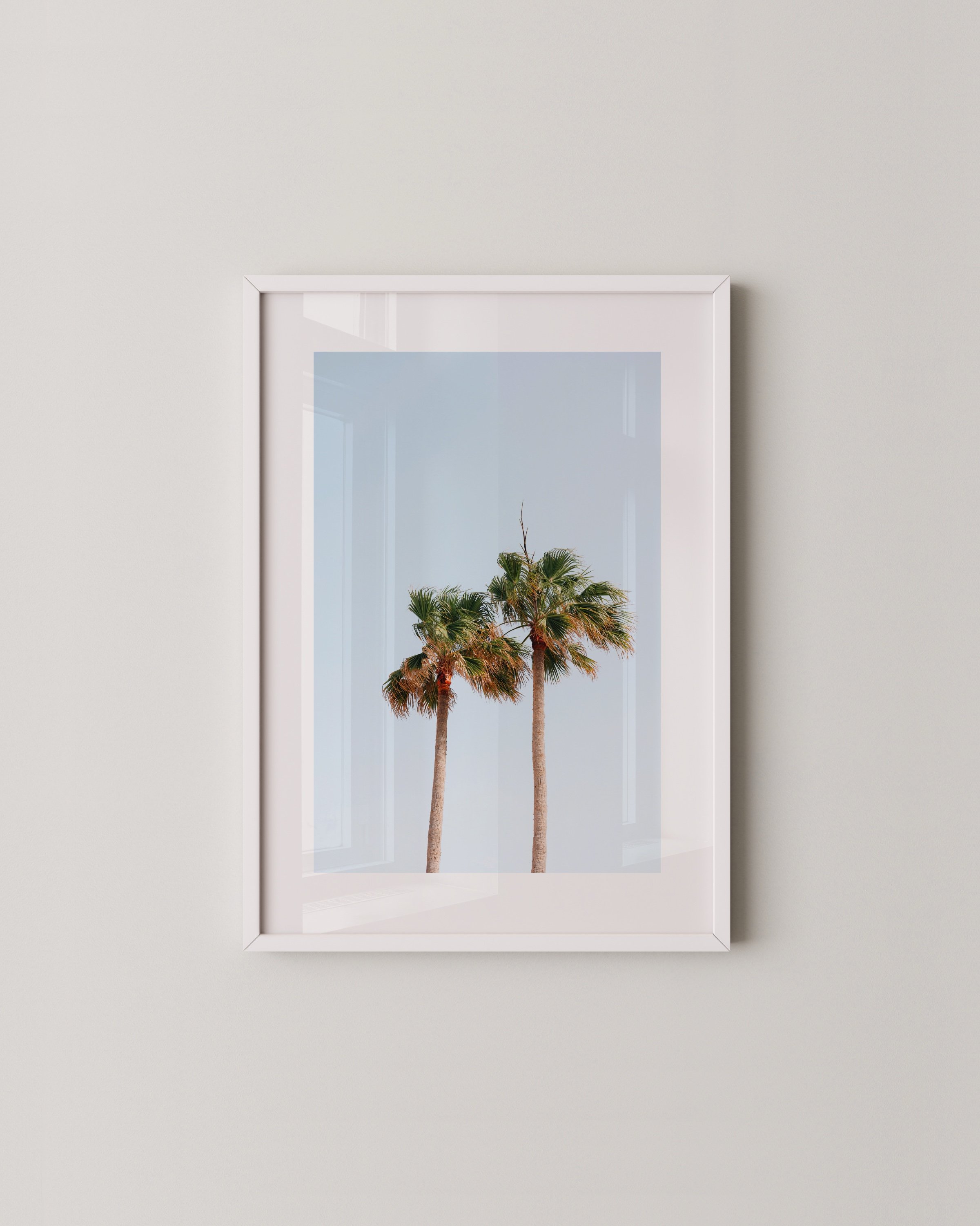 Set of three desert-themed wall art prints featuring cacti, palm trees, and minimalist architecture under a bright blue sky.