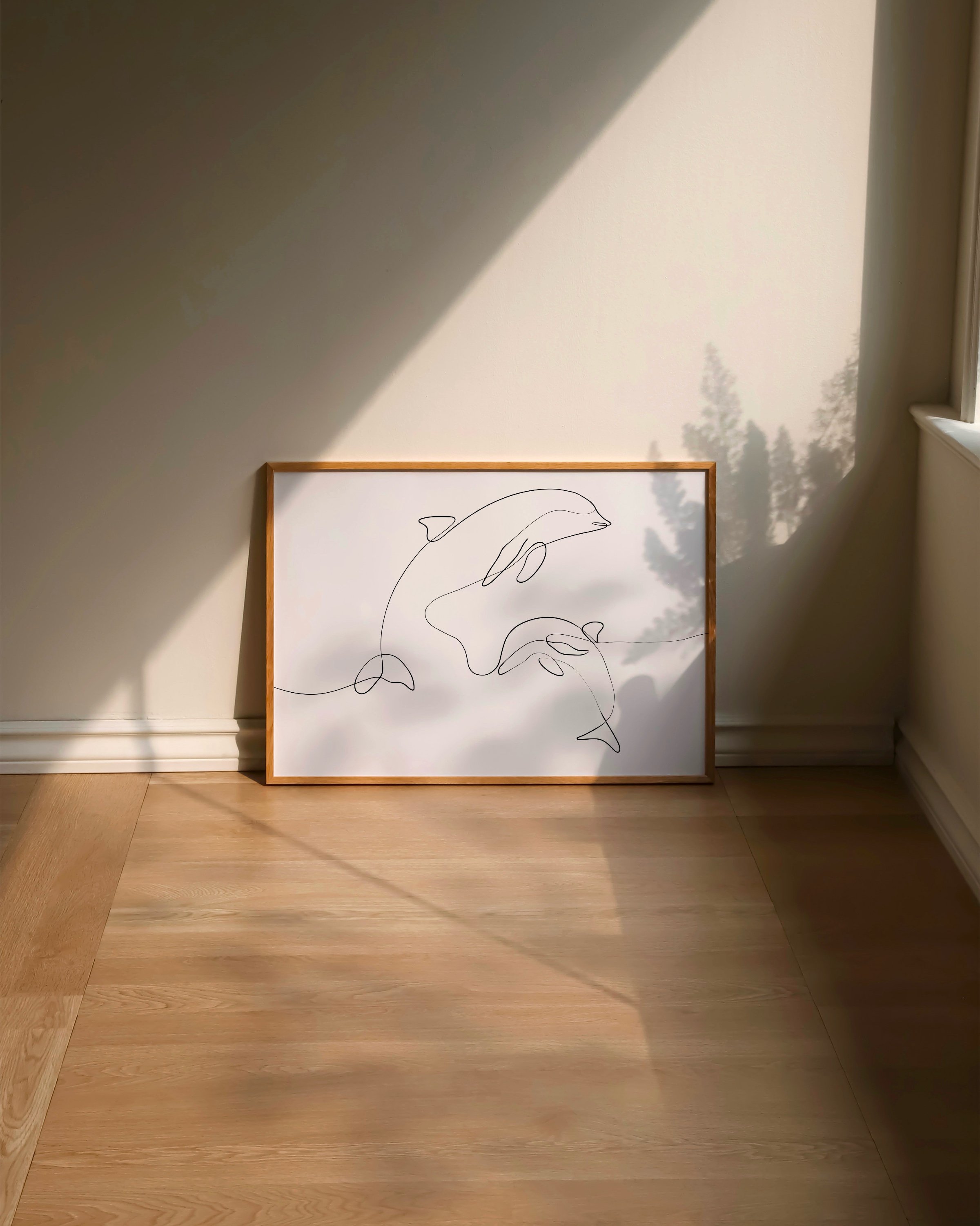 Minimalist line art print featuring dolphins swimming, created in a continuous line style for an elegant marine decor addition.