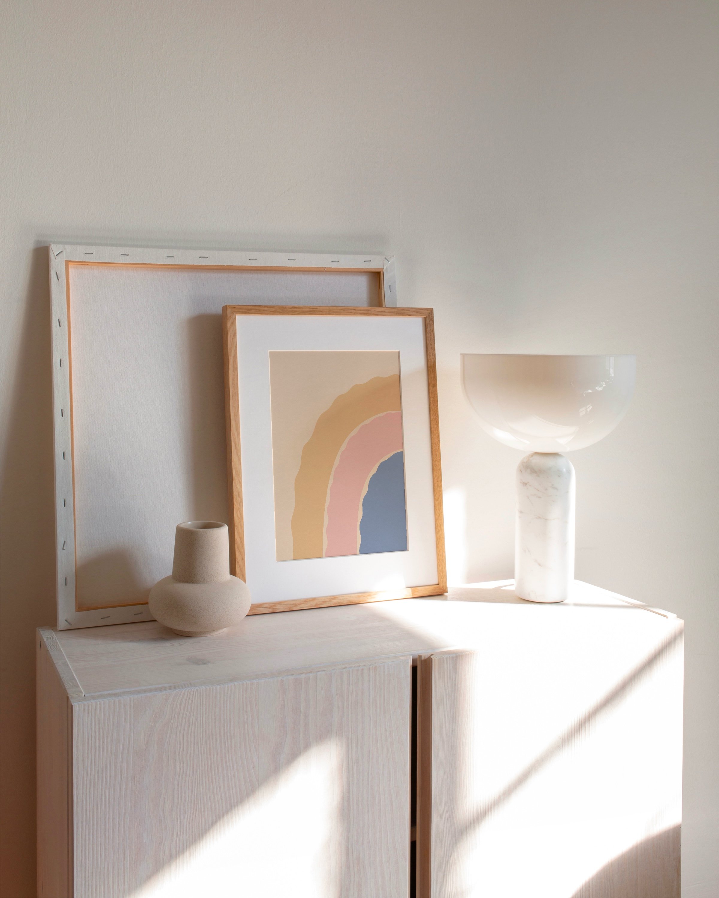 Abstract printable wall art featuring a wavy pastel rainbow in shades of peach, pink, and blue on a beige background.