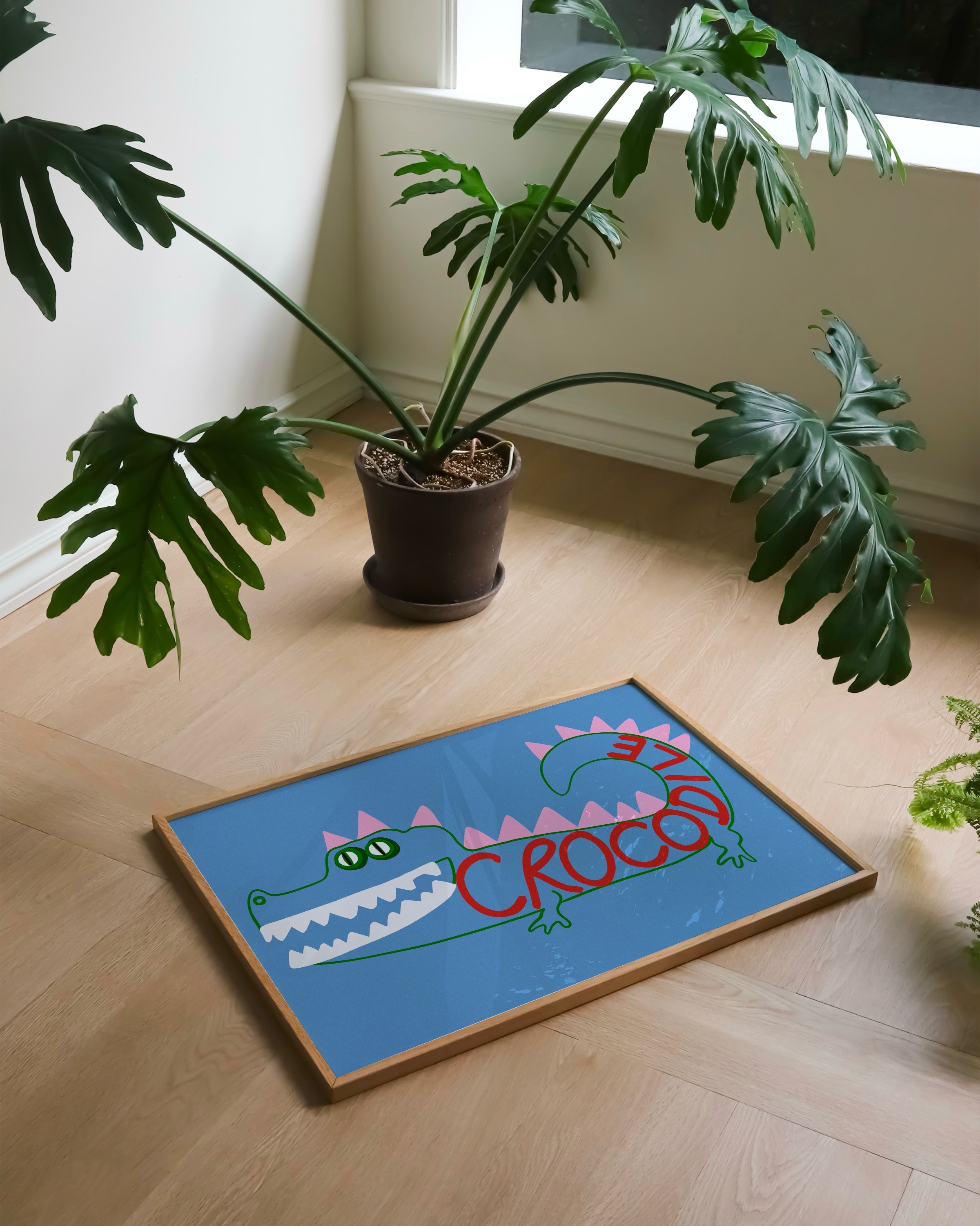 Playful crocodile art print with a blue background, featuring a colorful crocodile illustration with pink spikes and the word “Crocodile” in red.