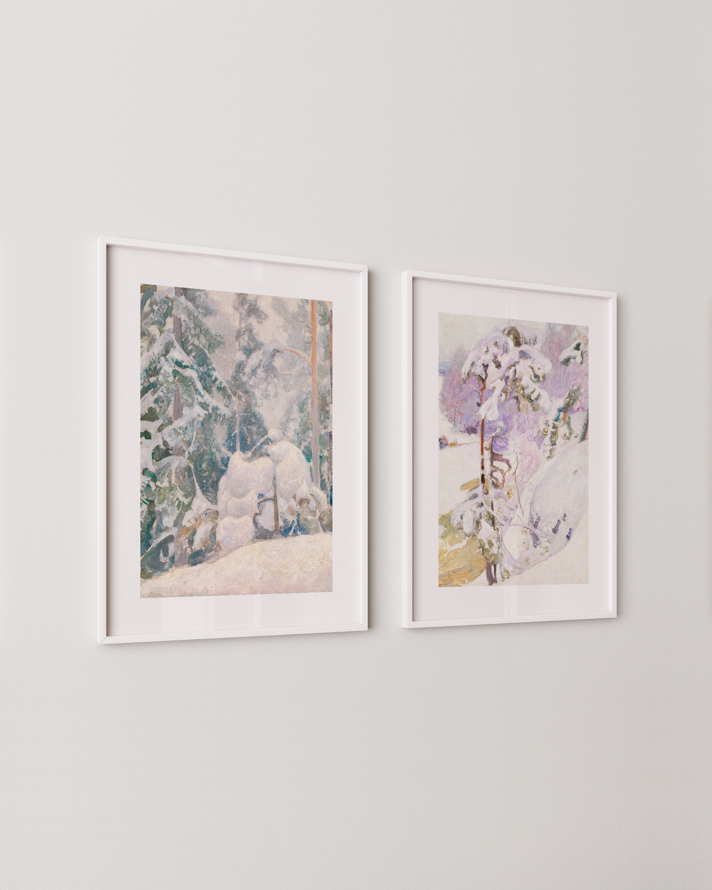 A two-piece winter wall art set featuring snowy forest landscapes in soft pastel tones, displayed in minimalist white frames.