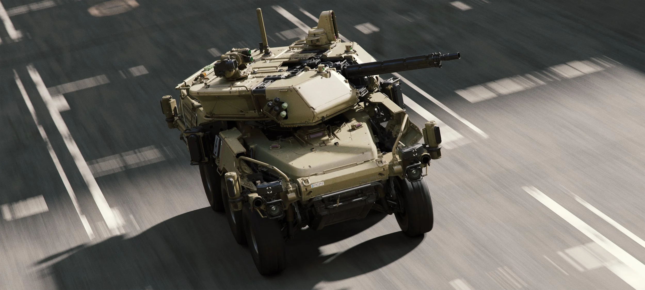 A military truck driving on a paved road with white lane markings, captured from an aerial perspective.