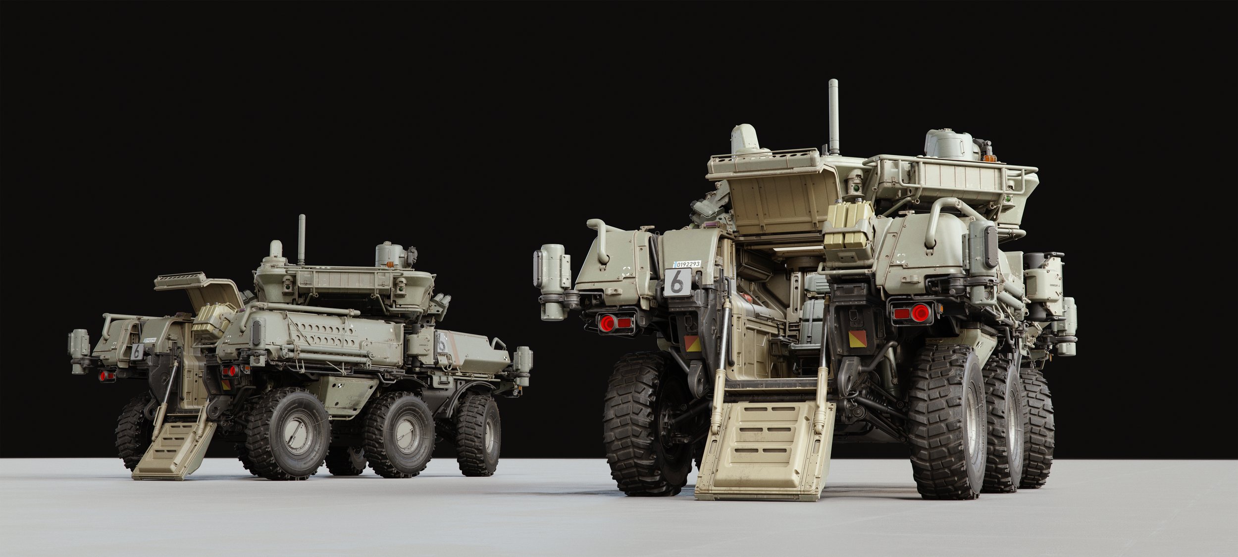 Two detailed model military vehicles with ramps and large tires, set against a black background.