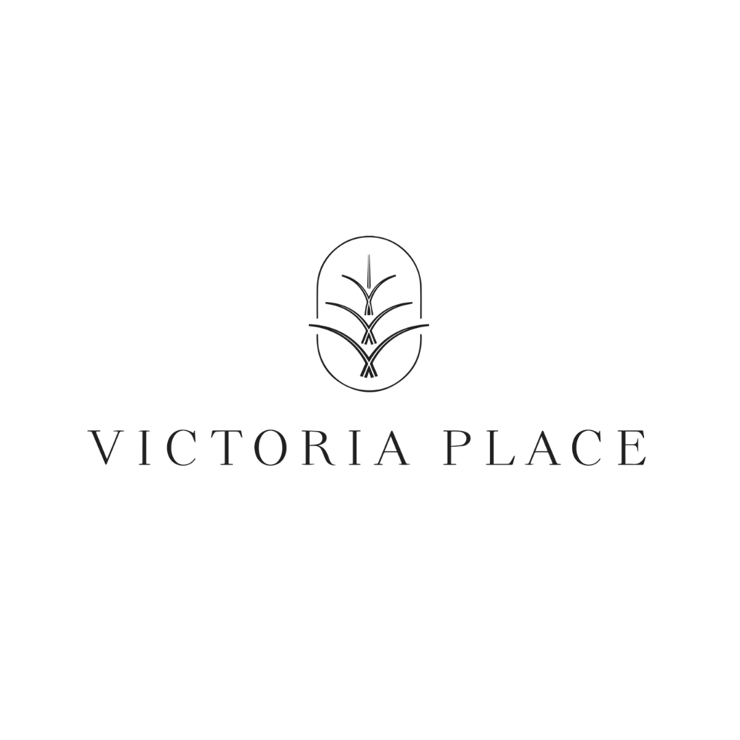 Logo with an oval shape containing a stylized leaf or plant design above the text 'Victoria Place' in black.