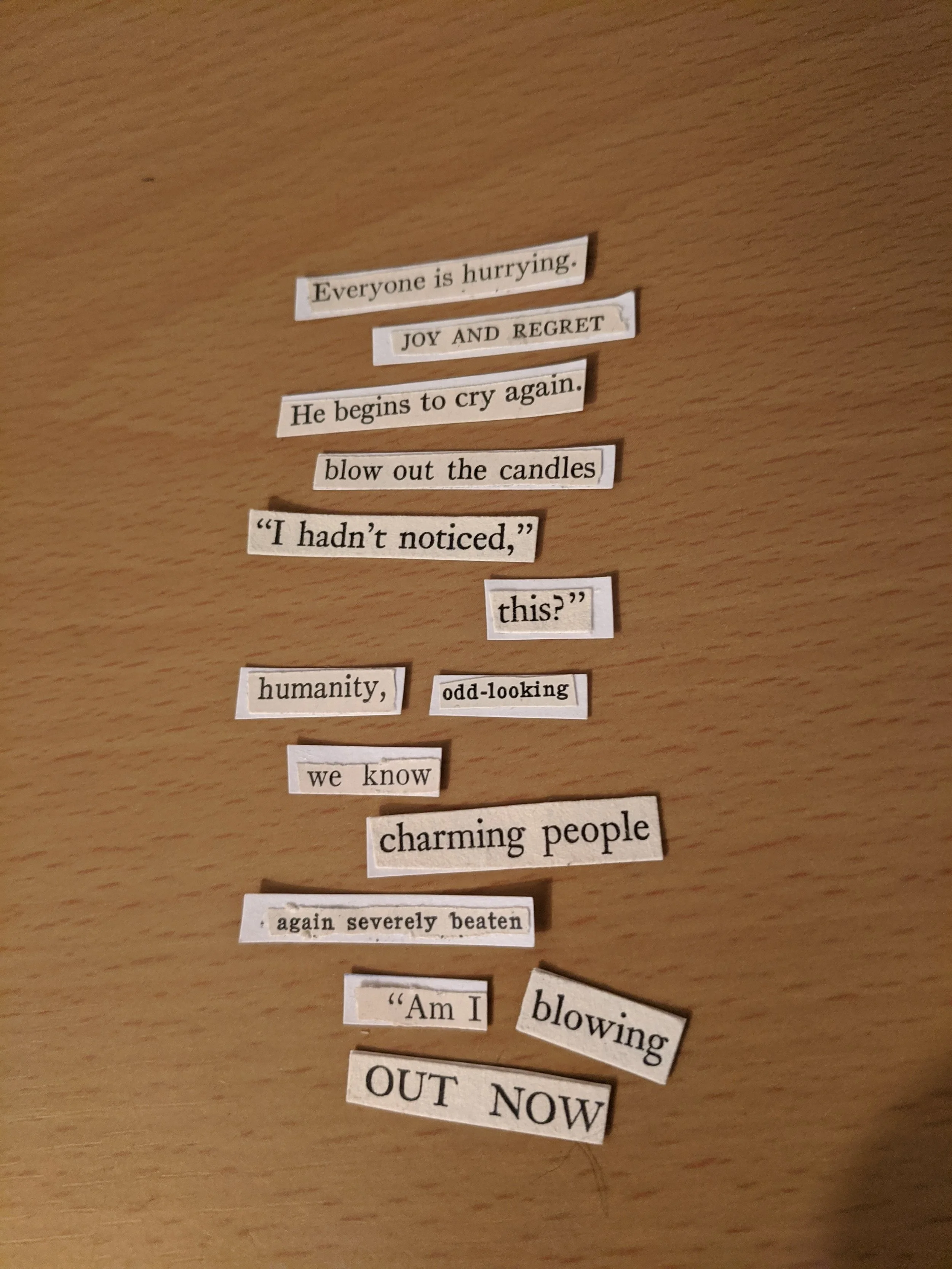A series of torn-out magazine or newspaper words arranged on a wooden surface, expressing emotions and actions related to celebration and resilience.