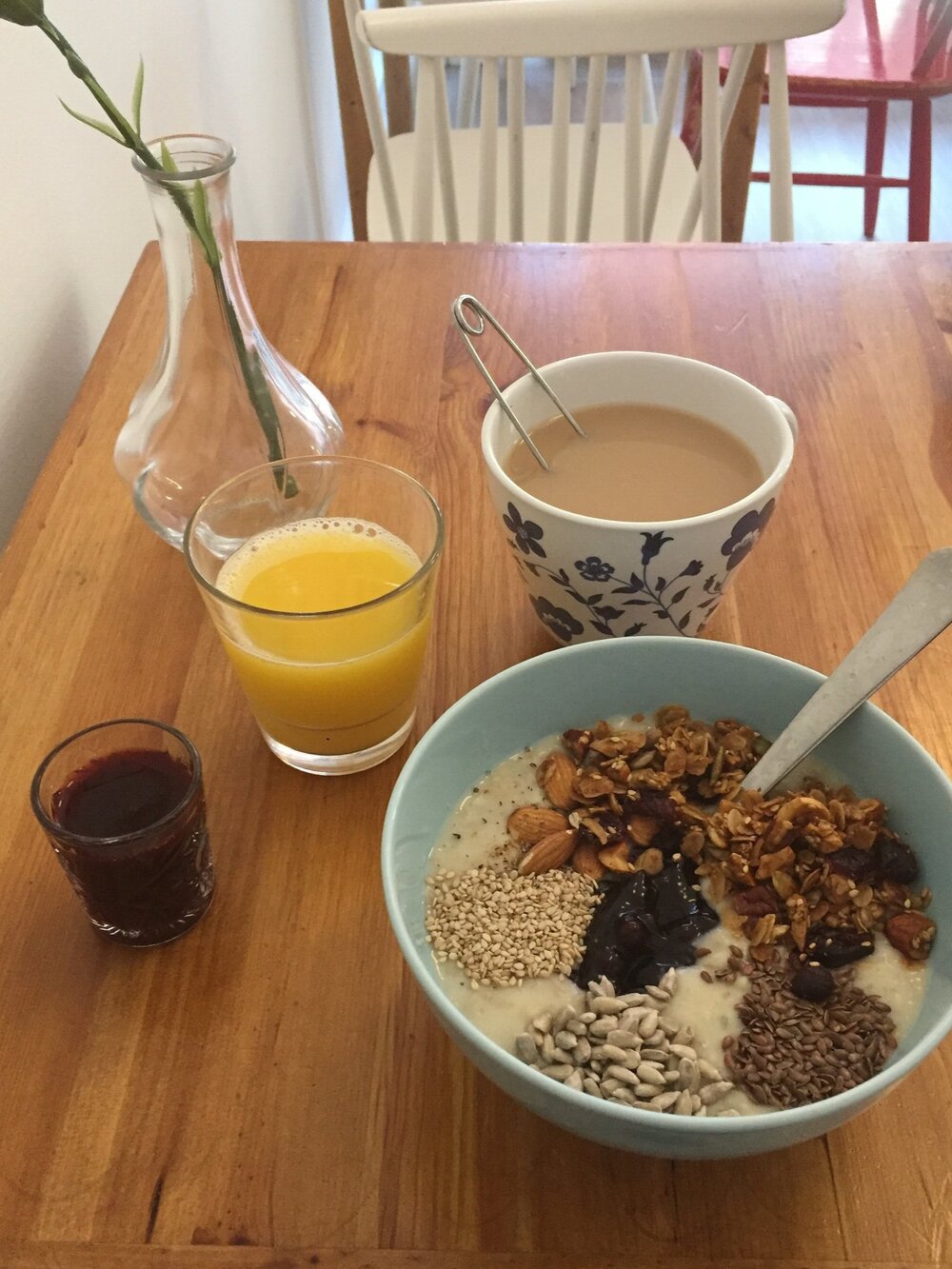  Breakfast of porridge, tea, orange juice and blueberry (?) juice 