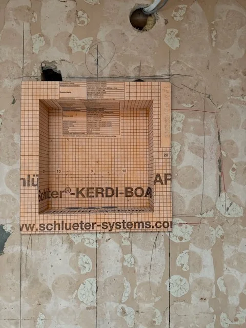 Recessed shower shelf framed with Schluter Kerdi-Board during London studio bathroom rebuild