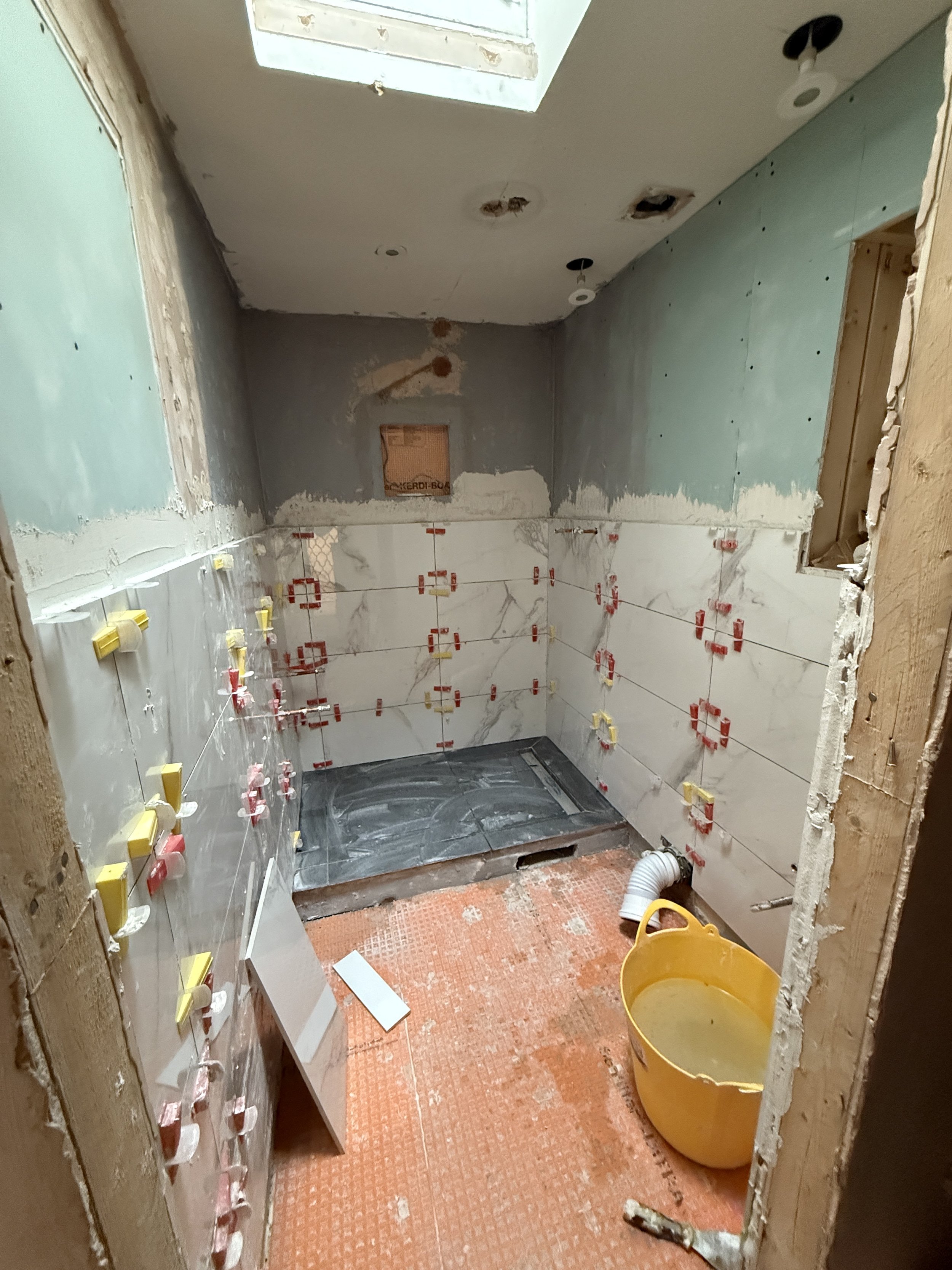 First round of tiles on the bathroom walls.JPG