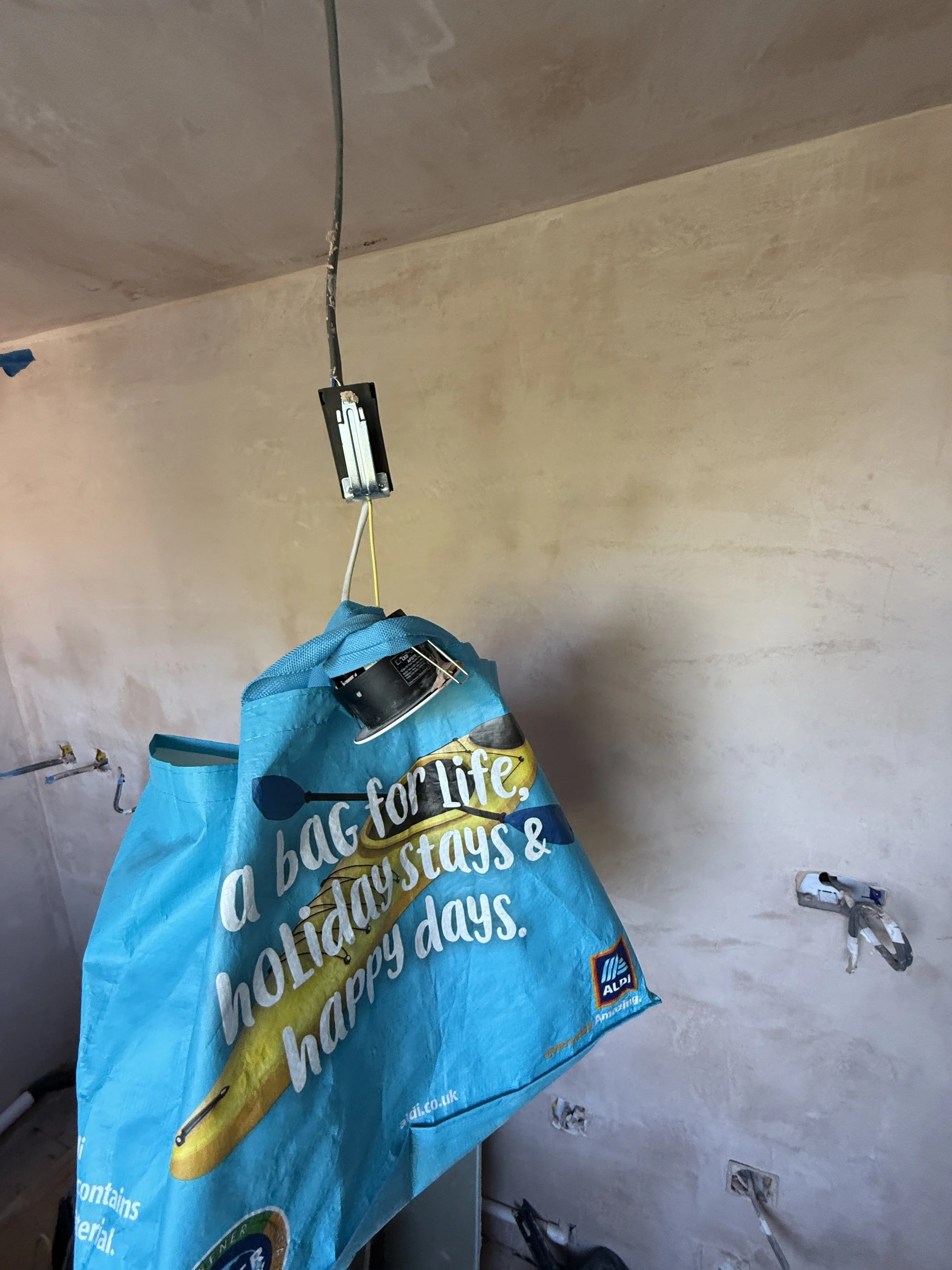 bag hanging from open electrics.JPG