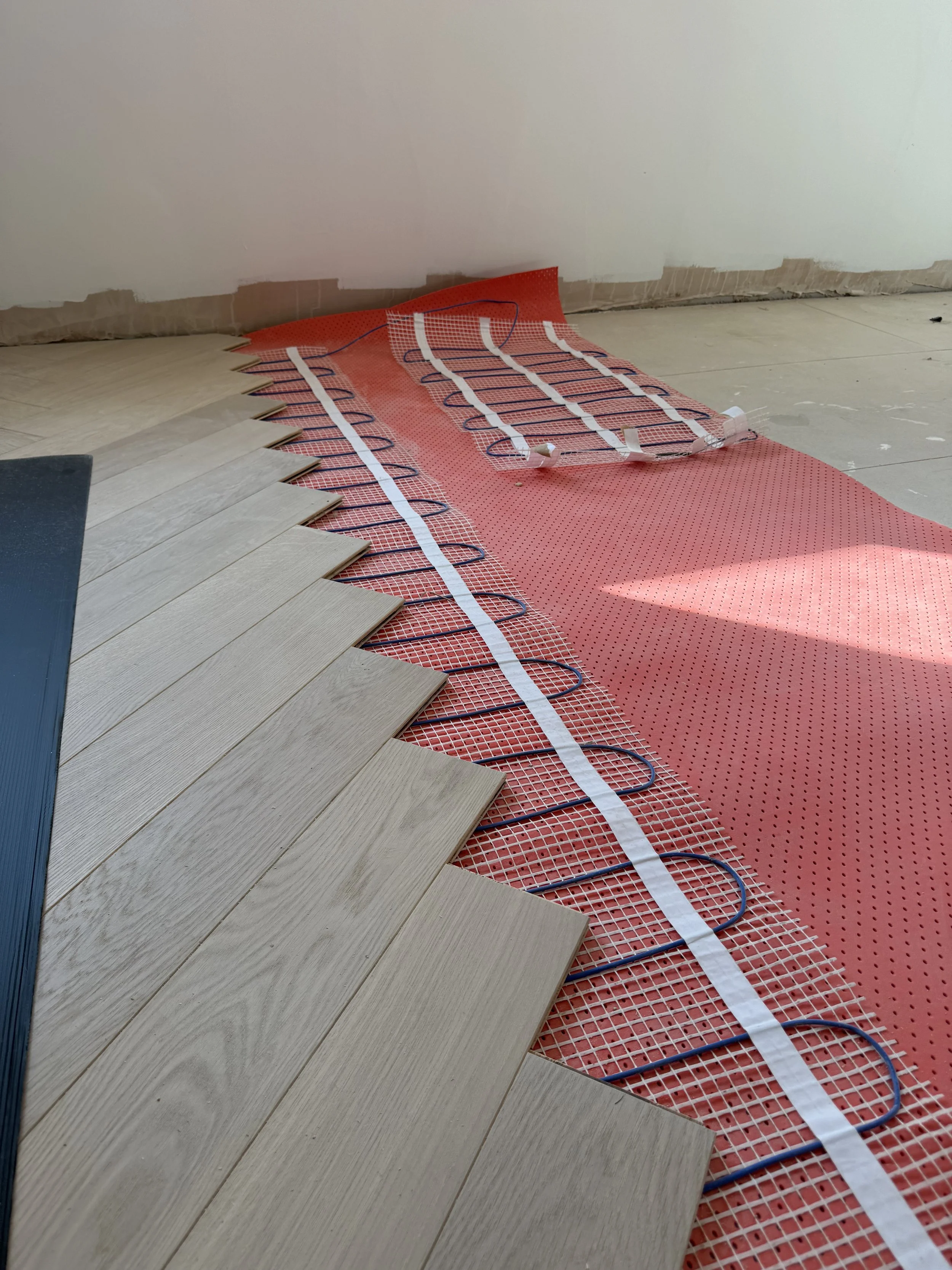 Tracks taped to the floor under herringbone.jpeg