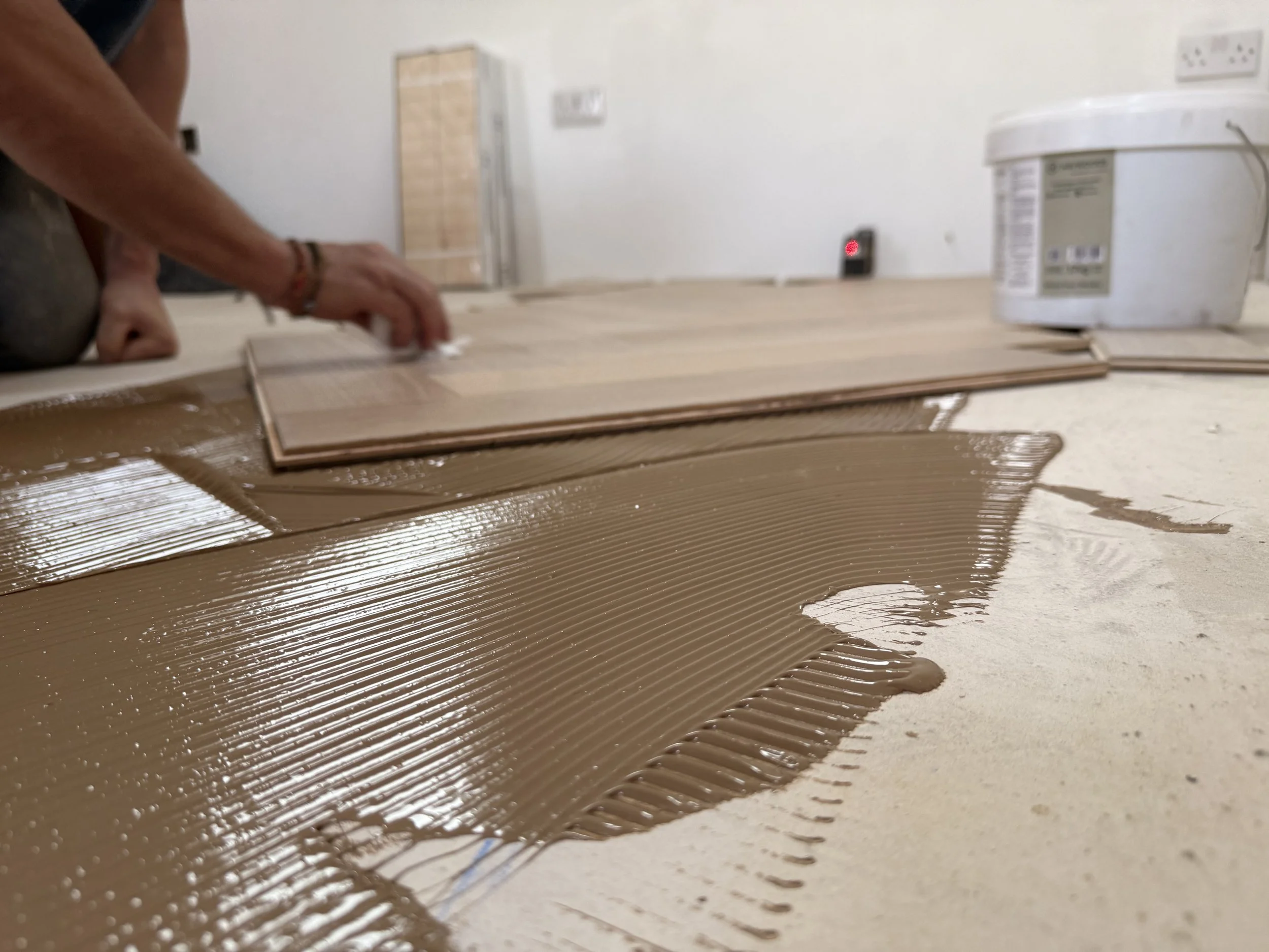 Gluing the flooring into place as it should be.jpeg