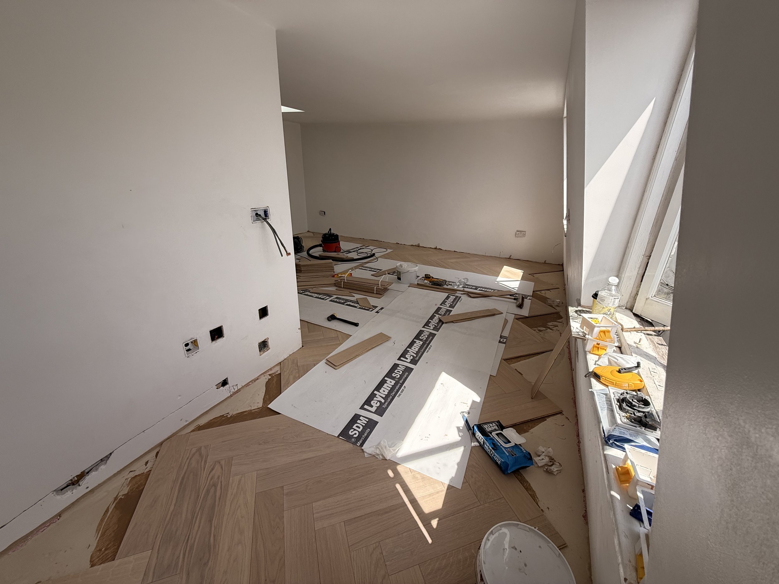 laying down floor protection as its was being laid.jpeg